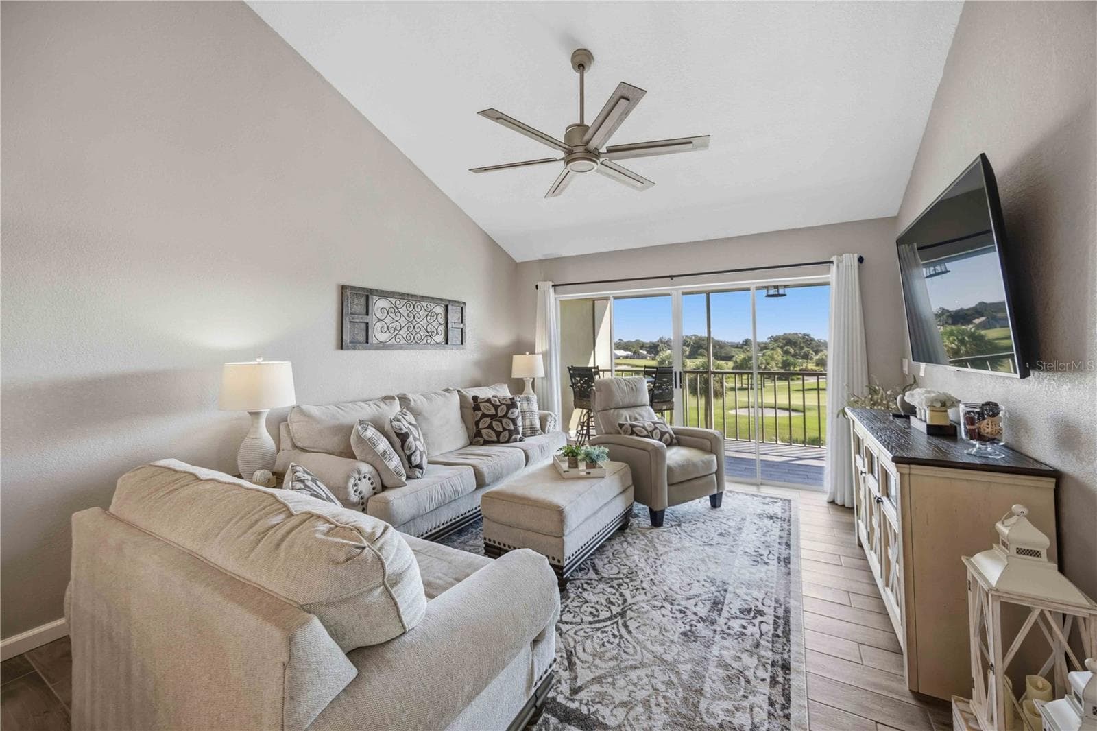 Comfortable living room features a soaring vaulted ceiling, abundant natural light and a beautiful outdoor backdrop. - 406 CERROMAR CIR N #328, VENICE