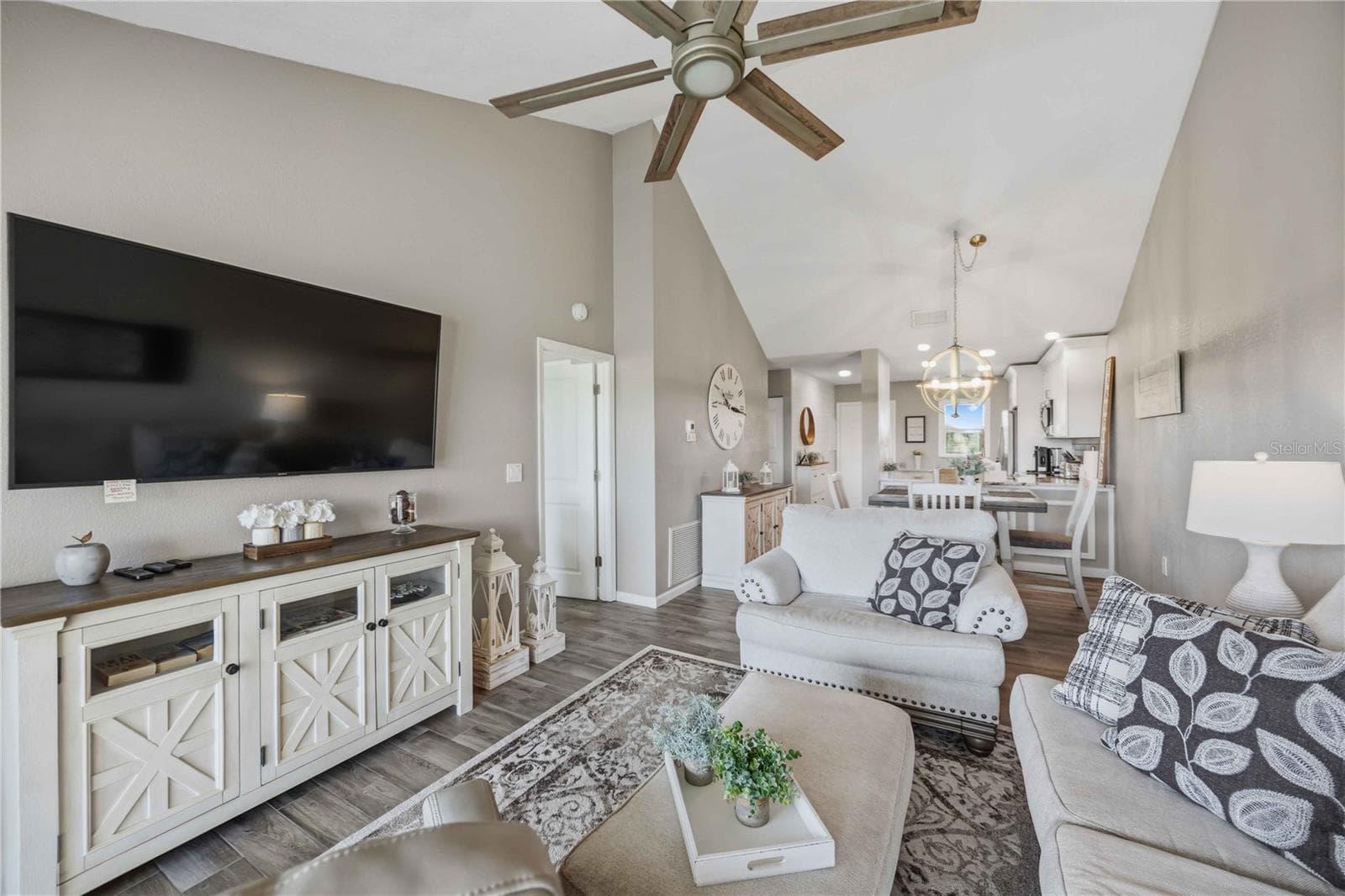 Spacious living area offers an airy feel with vaulted ceilings and large glass doors framing the view. - 406 CERROMAR CIR N #328, VENICE