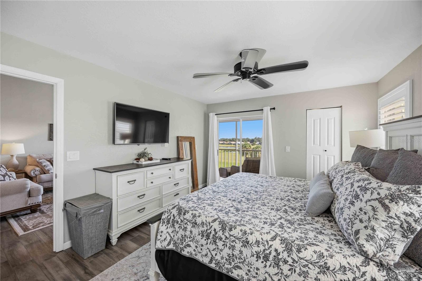 Spacious primary bedroom is filled with natural light and enjoys direct access to the screened outdoor living area. - 406 CERROMAR CIR N #328, VENICE
