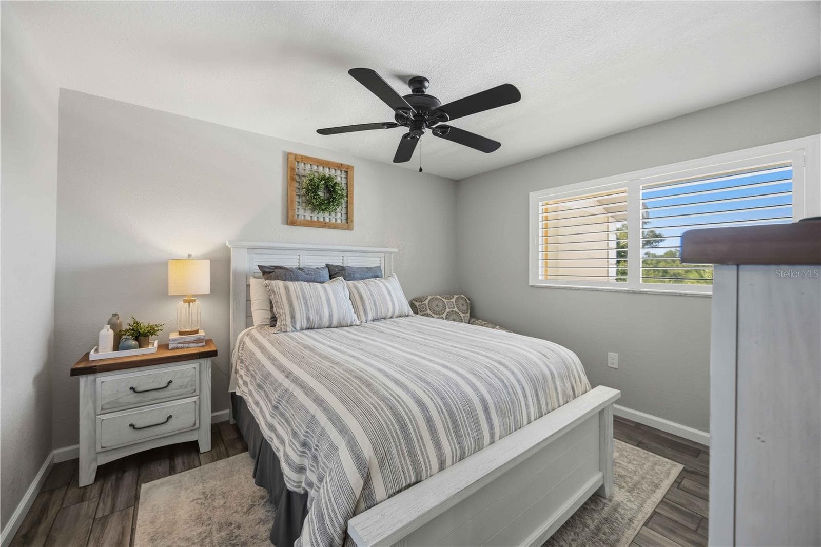 Bright secondary bedroom features attractive flooring, a ceiling fan and plenty of natural light. - 406 CERROMAR CIR N #328, VENICE