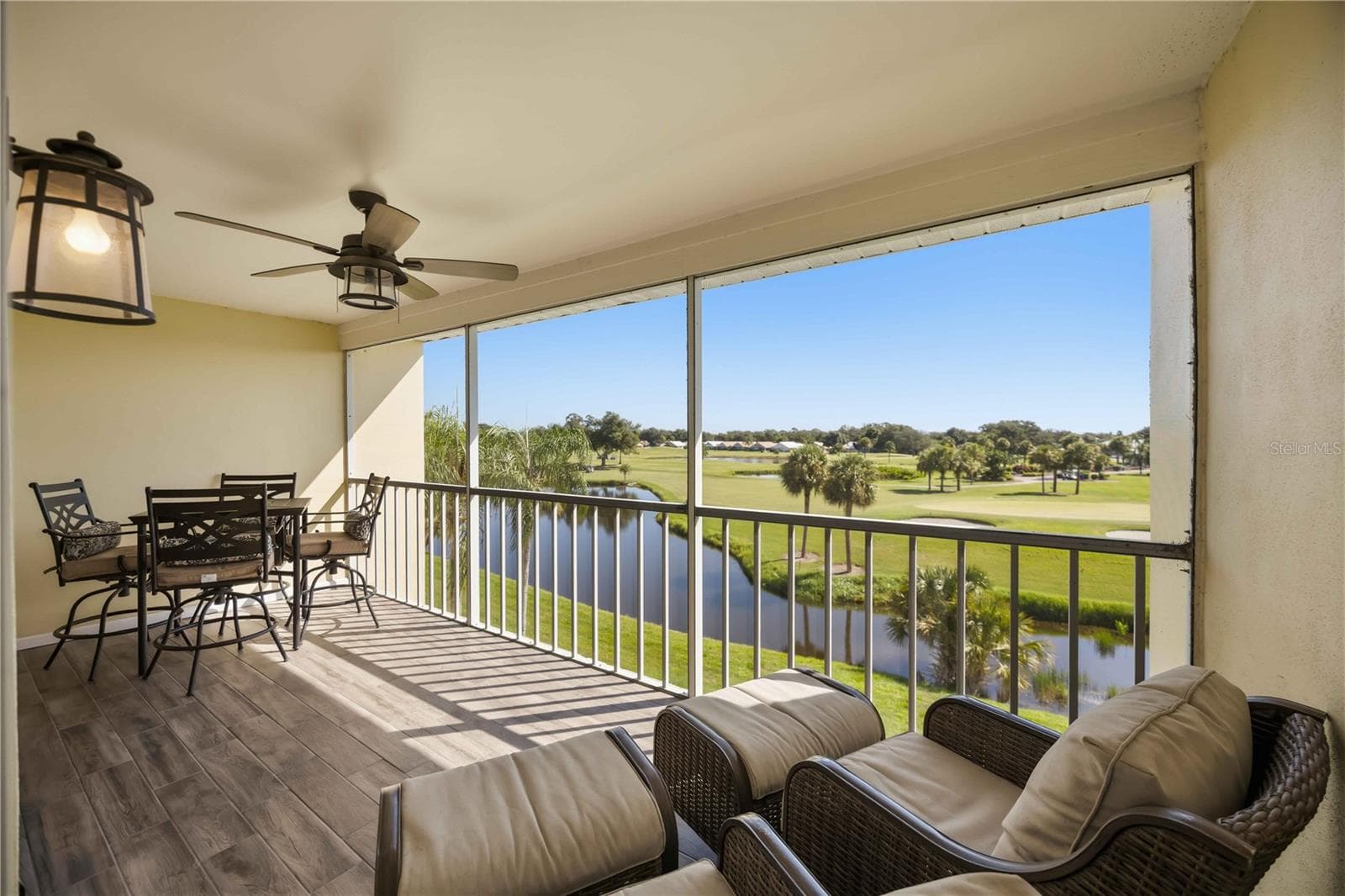 Expansive screened lanai offers a front-row seat to serene water and golf-course views. - 406 CERROMAR CIR N #328, VENICE