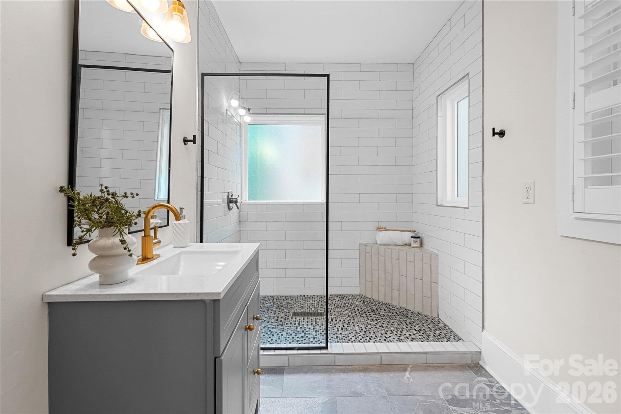 Updated main-level full bath adds flexibility for guests or multi-generational living. - Charlotte