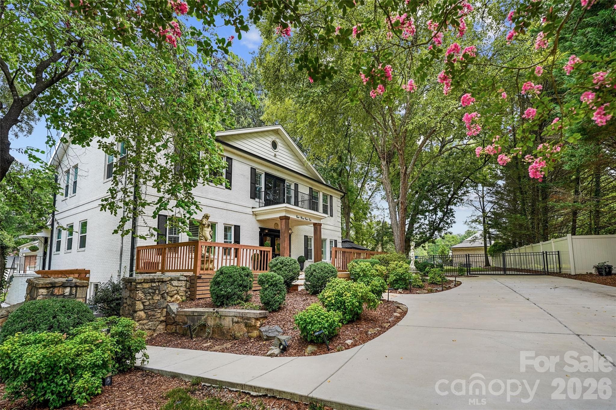 Two driveways provide ample parking for residents and guests. - Charlotte