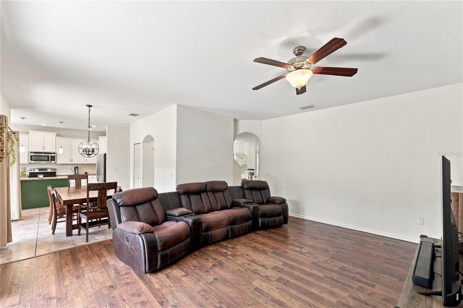 Living room large enough to hold multiple sofa pieces - 16613 MYRTLE SAND DR, WIMAUMA
