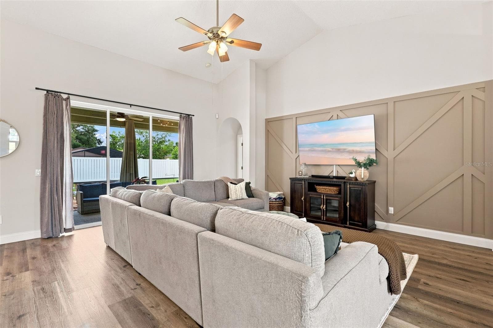 Main living area with vaulted ceiling and porch access - 96 PARKVIEW DR, PALM COAST