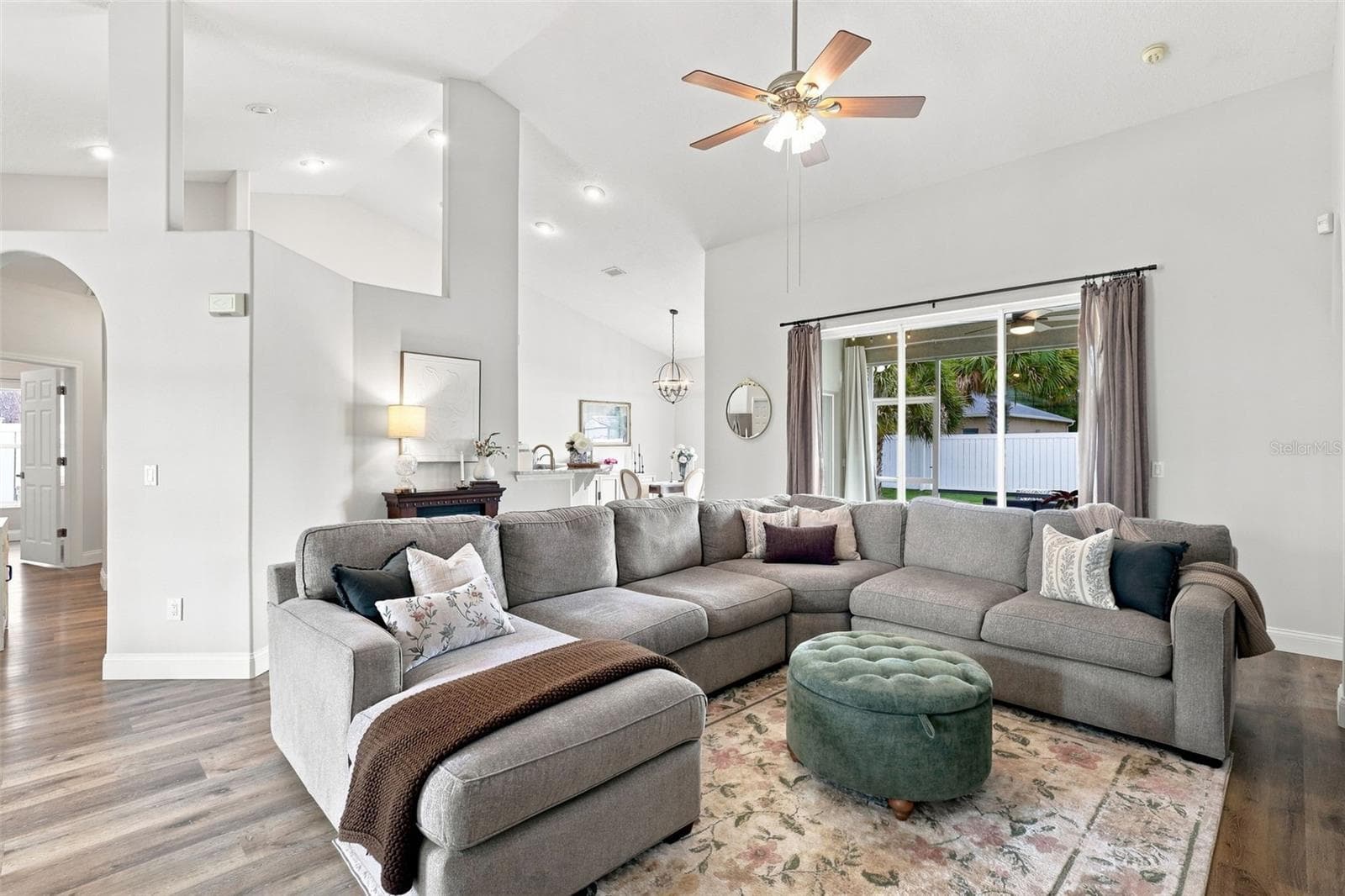 Main living area towards triple pocket sliders and the screened lanai. - 96 PARKVIEW DR, PALM COAST