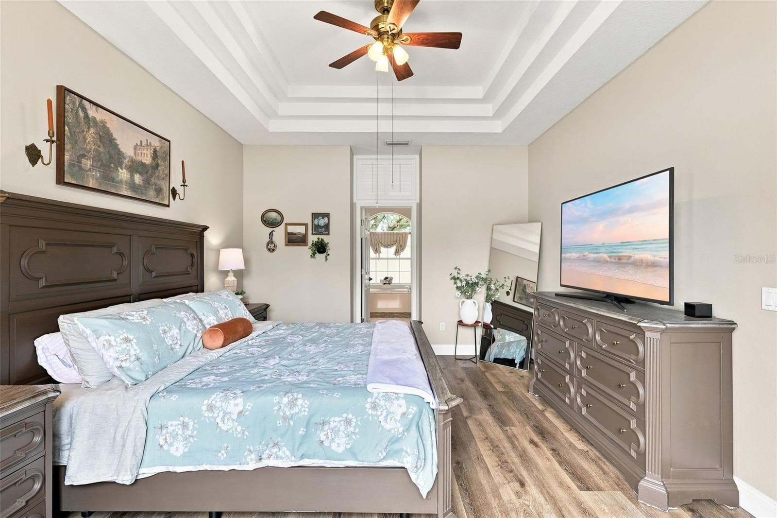 Primary bedroom with gorgeous tray ceiling and ceiling fan. - 96 PARKVIEW DR, PALM COAST