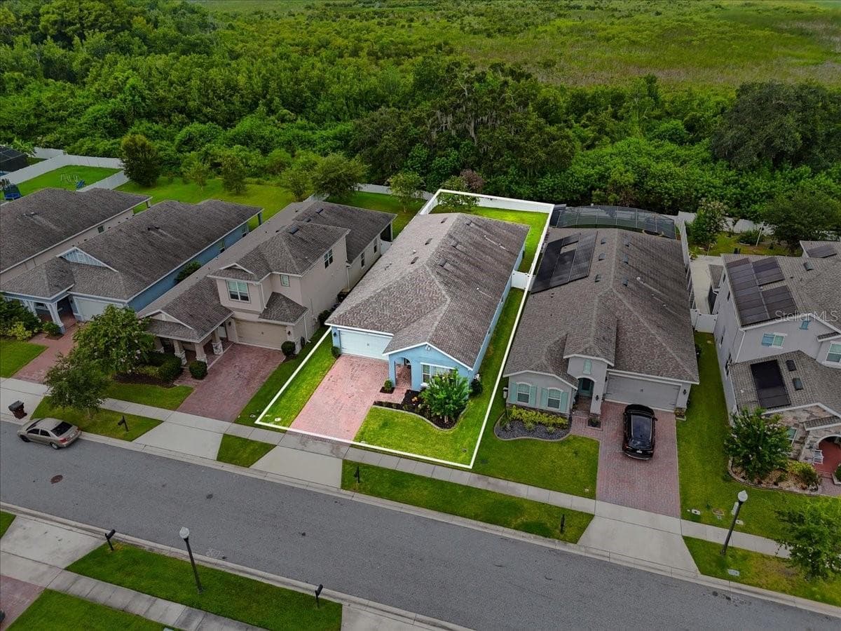 A generously sized, fully fenced backyard extends to lush conservation, creating a private outdoor retreat with no rear neighbors and room to truly enjoy the Florida lifestyle. - 4791 RIVERWALK DR, ST CLOUD