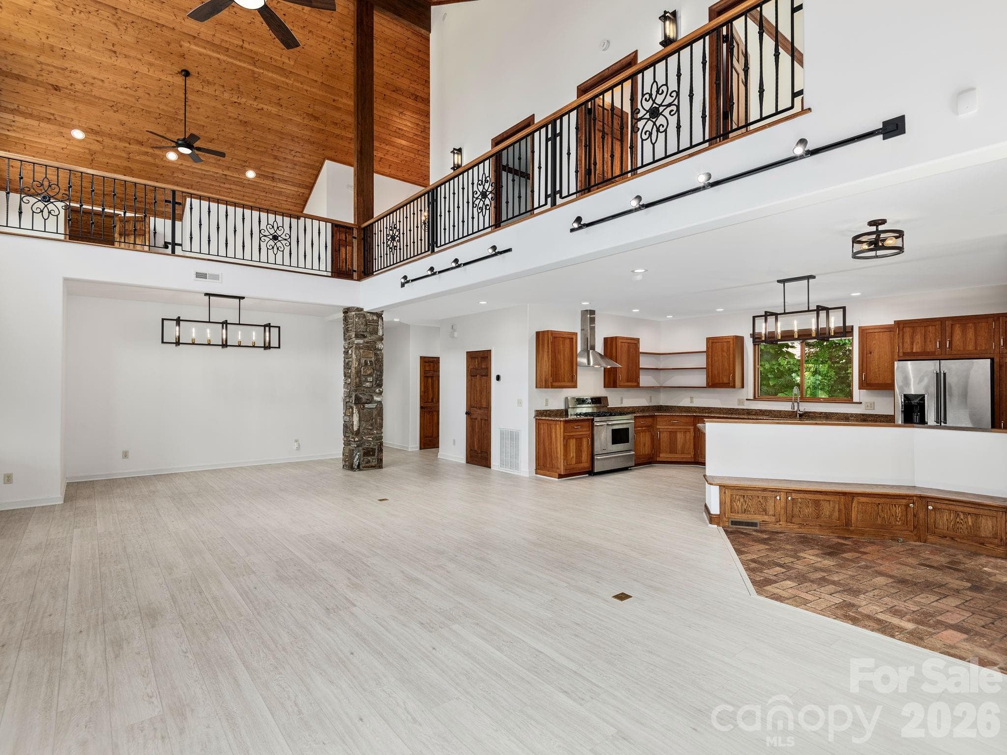 Open Living Great Room, Dining and Kitchen. View of Loft area. - 248 Wisdom Cove Road, Flat Rock