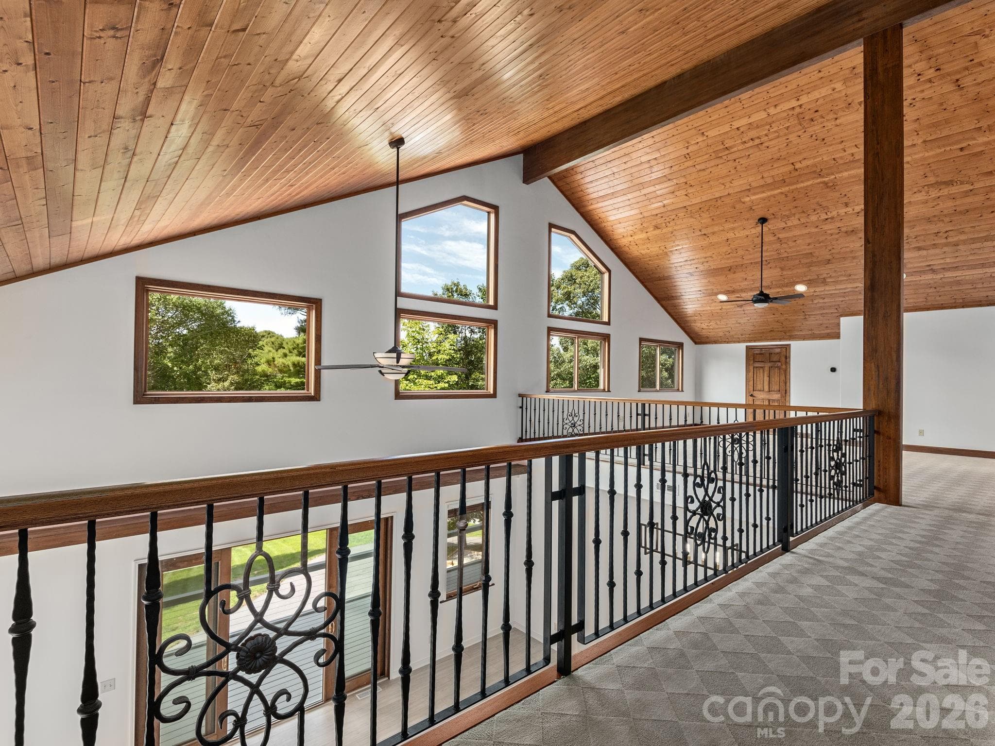 View to upper level loft area from two bedrooms. Beautiful windows lets in the light. - 248 Wisdom Cove Road, Flat Rock