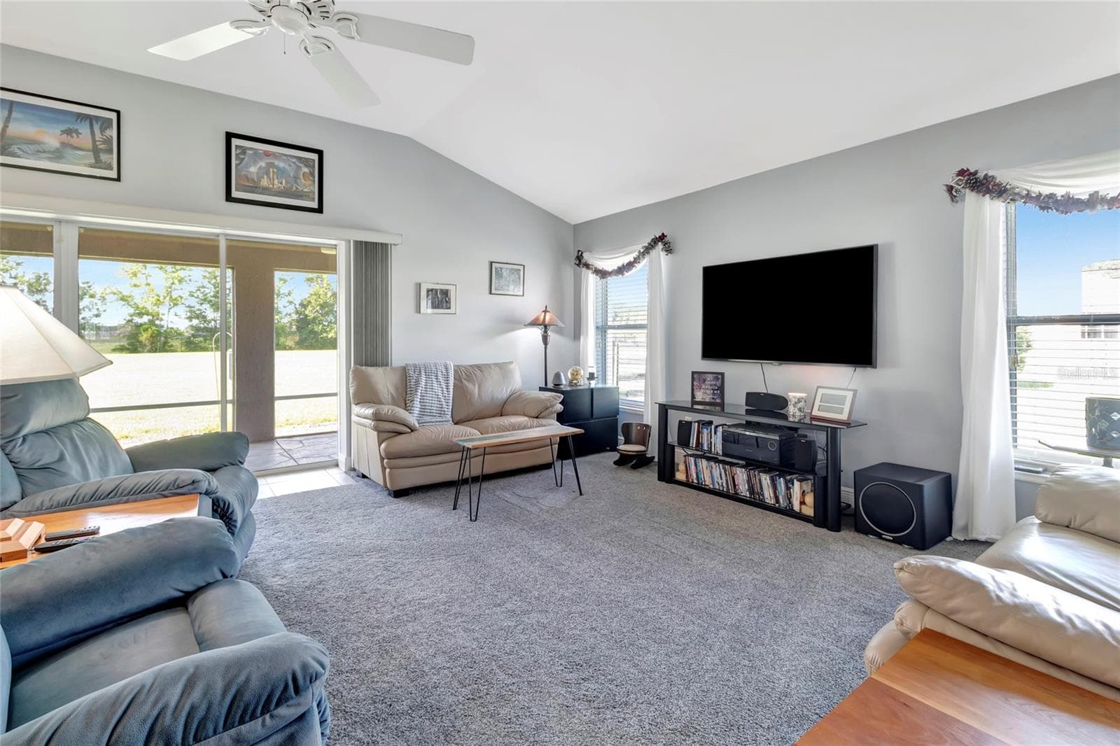 Large cozy and inviting living room. Plenty of natural light that comes in from the double sliders to the back lanai area. - 4190 COUNTY ROAD 121D, WILDWOOD