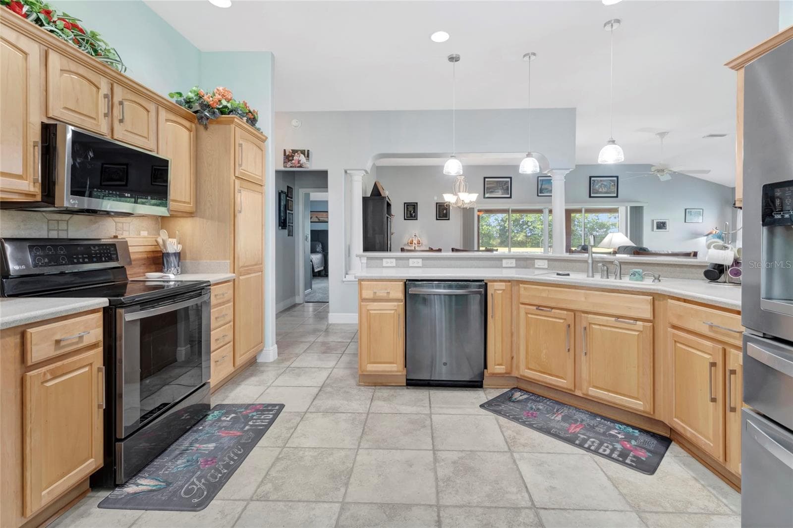 Beautifully lit eat in bar area around the large kitchen area with tile floors. - 4190 COUNTY ROAD 121D, WILDWOOD