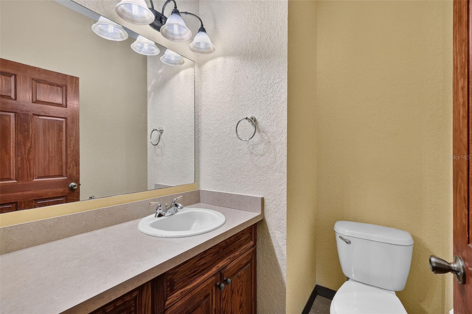 A convenient powder room on the main level means guests never have to venture far. - 4617 ROUND LAKE RD, APOPKA