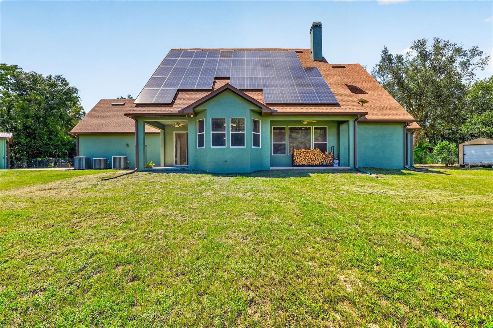 Multiple outdoor living zones and a generous flat yard provide endless potential for a pool, garden, or outdoor kitchen. - 4617 ROUND LAKE RD, APOPKA