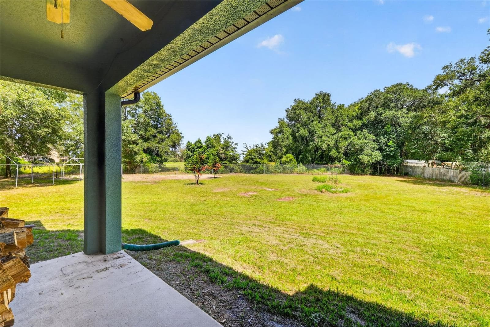Relax under the covered patio with ceiling fan as you take in views of the shaded, fully fenced backyard. - 4617 ROUND LAKE RD, APOPKA