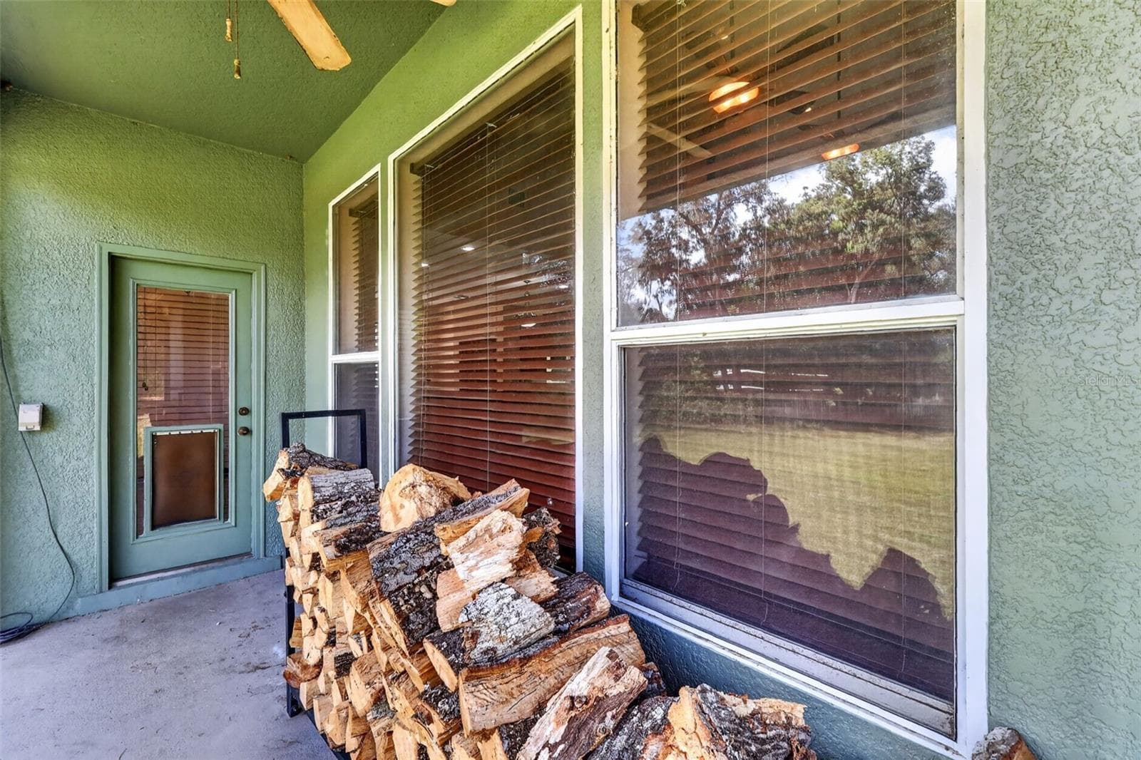 Cozy evenings by the fire start right here, with firewood stacked and ready just steps from the great room's stacked stone fireplace. - 4617 ROUND LAKE RD, APOPKA