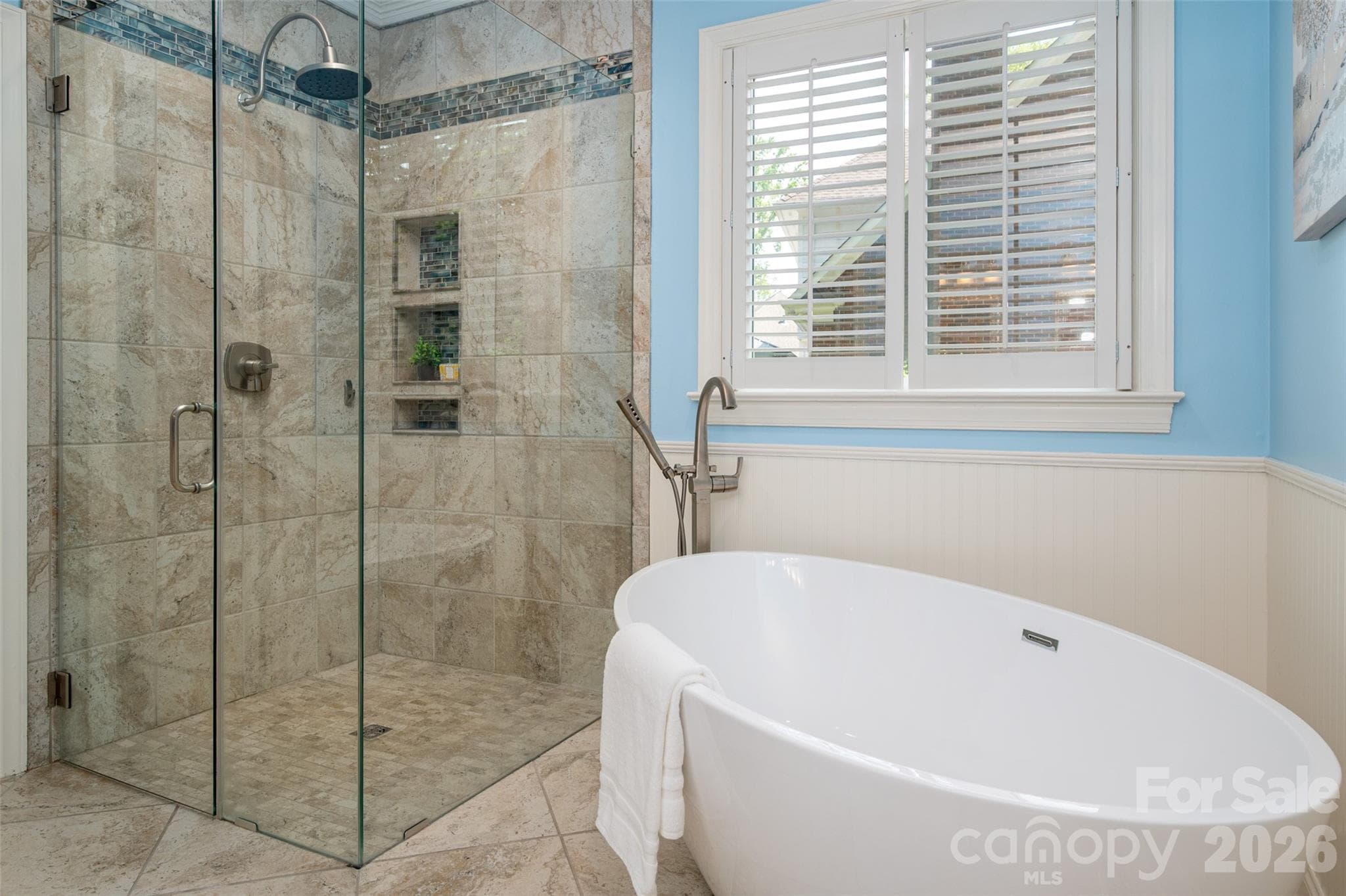 Zero entry shower with safety glass and a nice deep soaking tub. - 12818 Darby Chase Drive, Charlotte