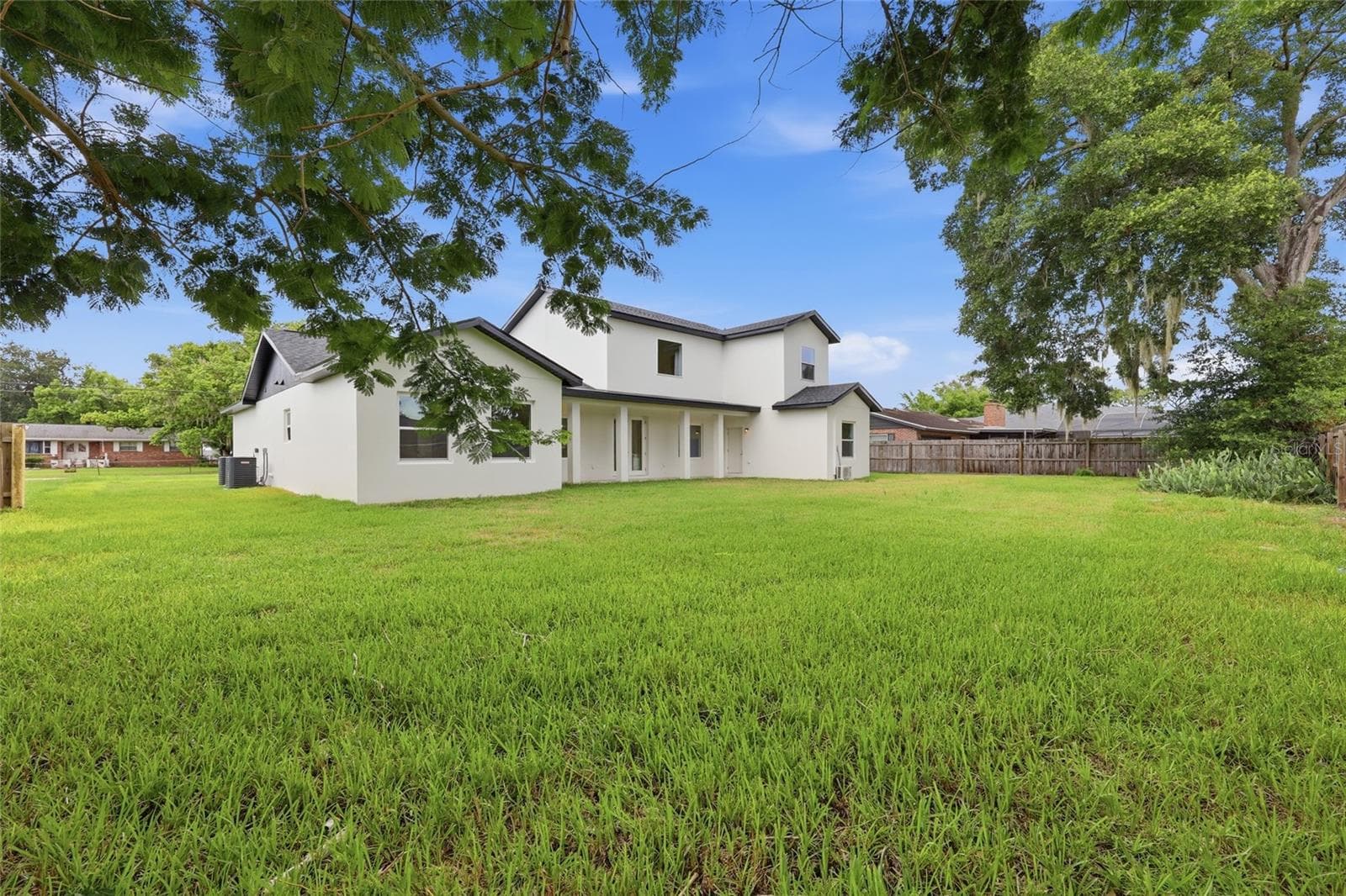 Rear exterior, tree-framed view - 351 E WILDMERE AVE, LONGWOOD