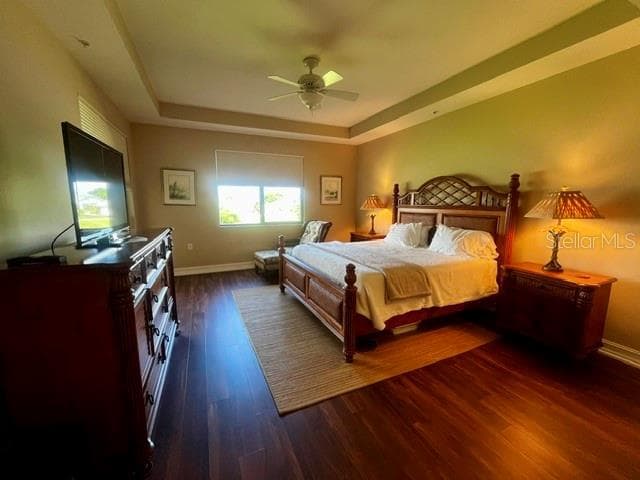 Primary bedroom with tray ceilings, luxury vinyl flooring, and electric window coverings - 88 VIVANTE BLVD #8822, PUNTA GORDA
