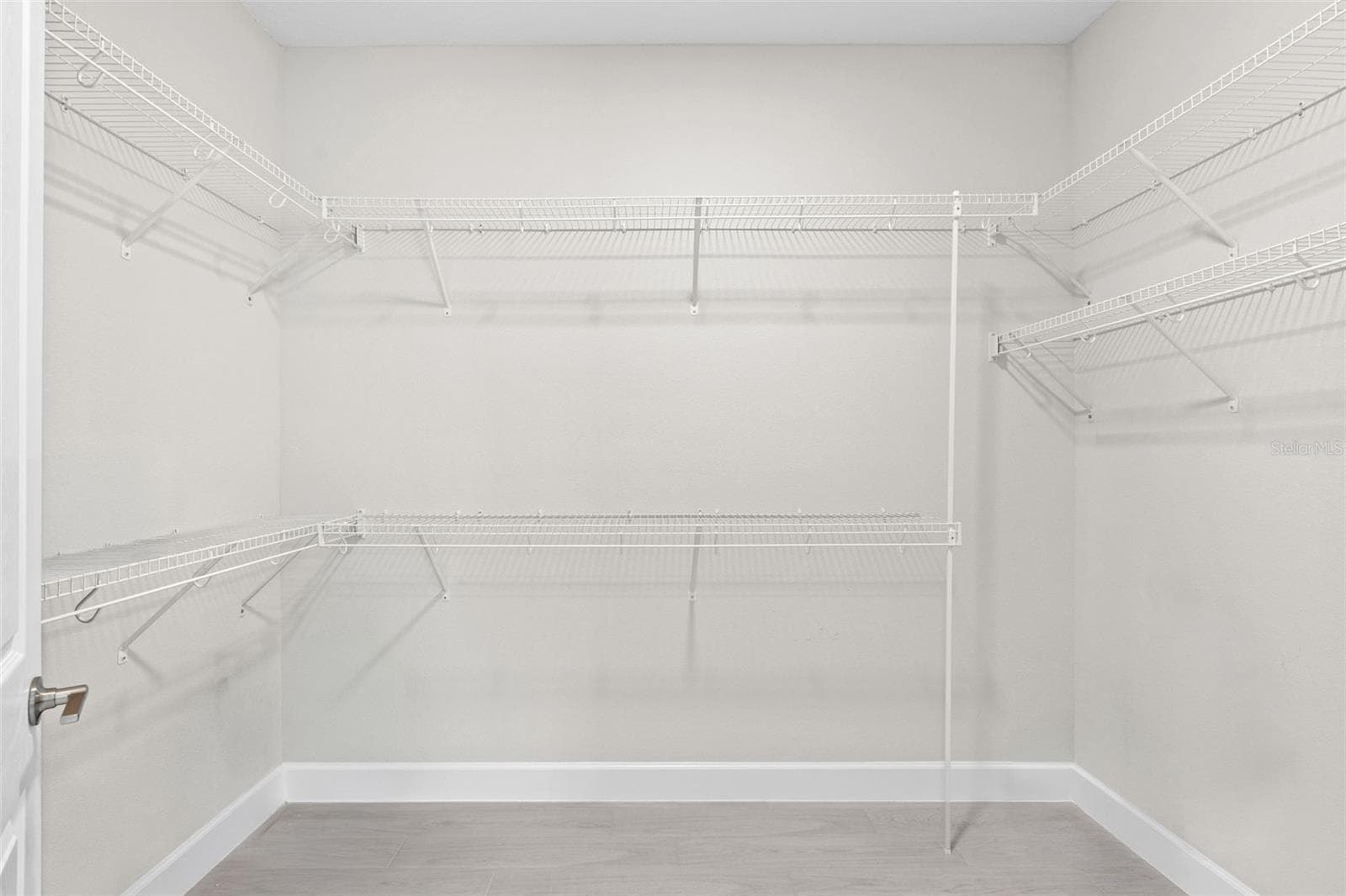 One of two walk-in closets in the primary suite. - 3336 LONE CYPRESS PT, OVIEDO
