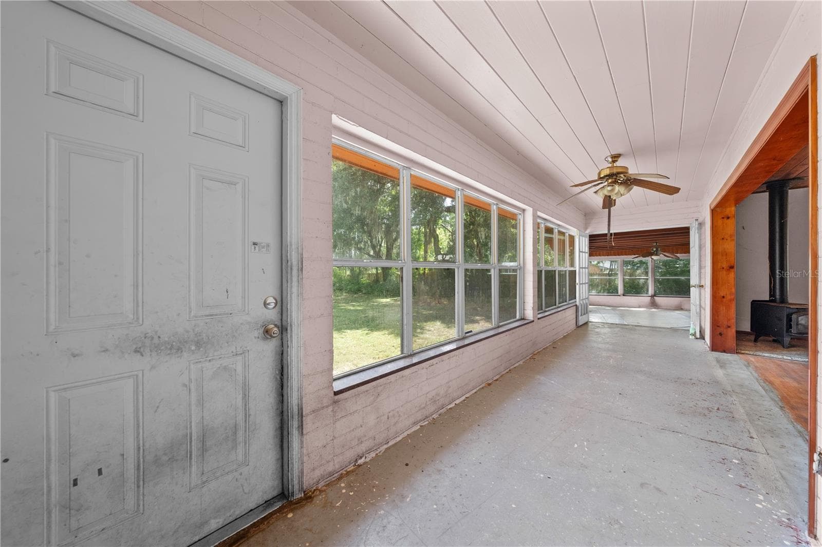 Sunroom that shows the front door of the home that faces the lake. - 2557 AMES HAVEN RD, KISSIMMEE