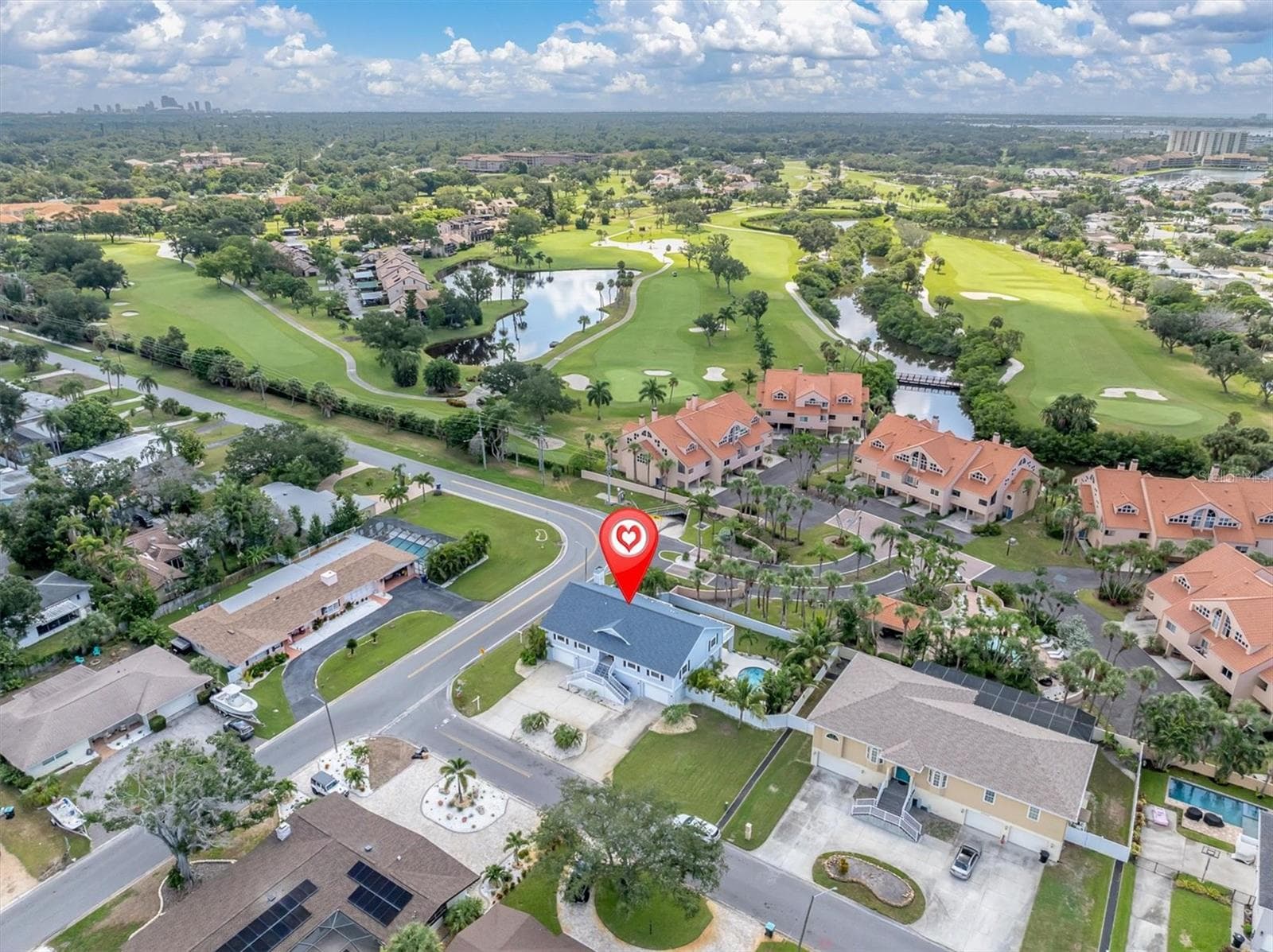 Aerial view overlooking the home, surrounding residences, and the beautiful Pasadena Yacht & Country Club golf course. - 6501 MOCKINGBIRD WAY S, GULFPORT