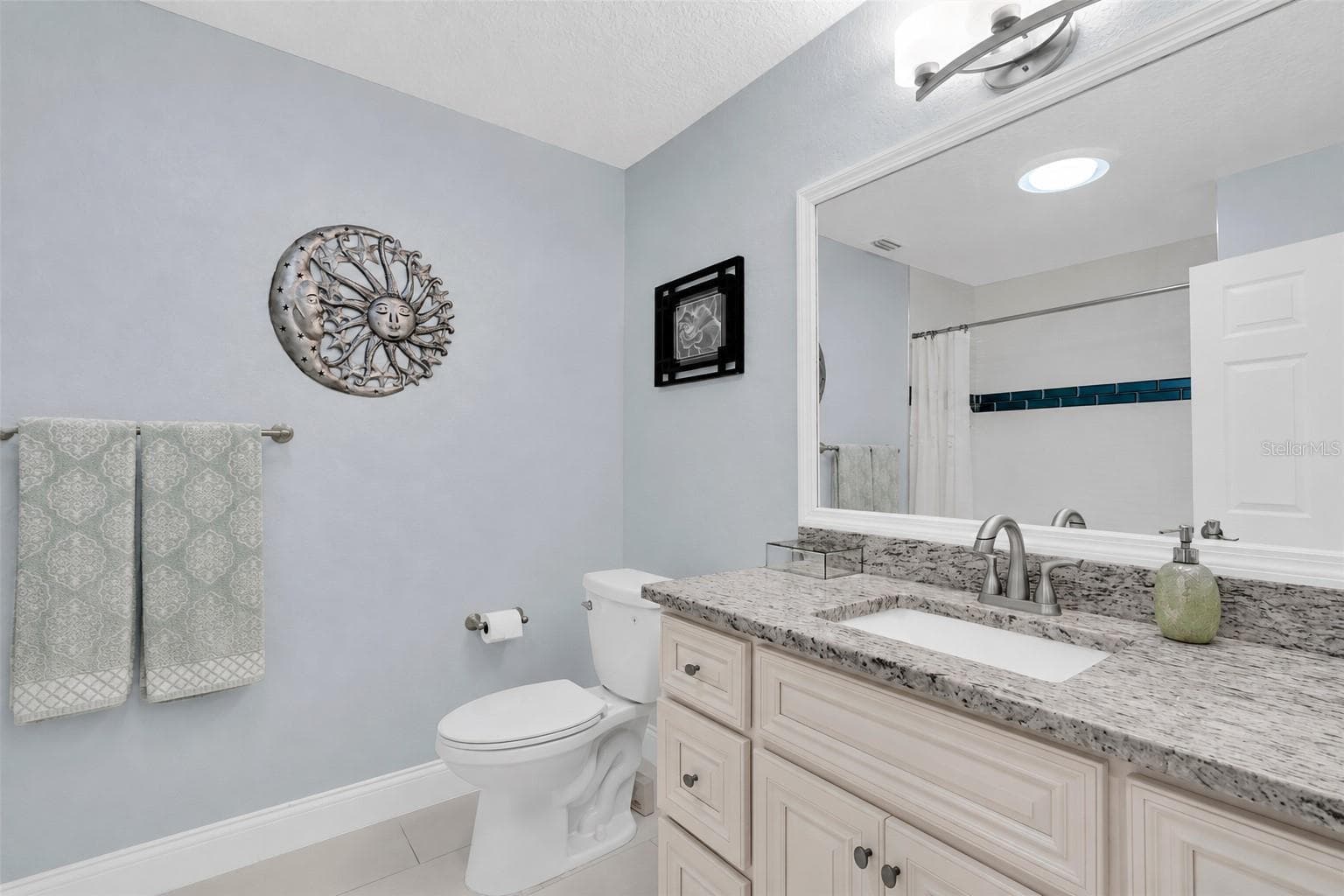 Spacious second bathroom featuring a tub & shower combination, granite countertop & classic porcelain sink. - 6501 MOCKINGBIRD WAY S, GULFPORT