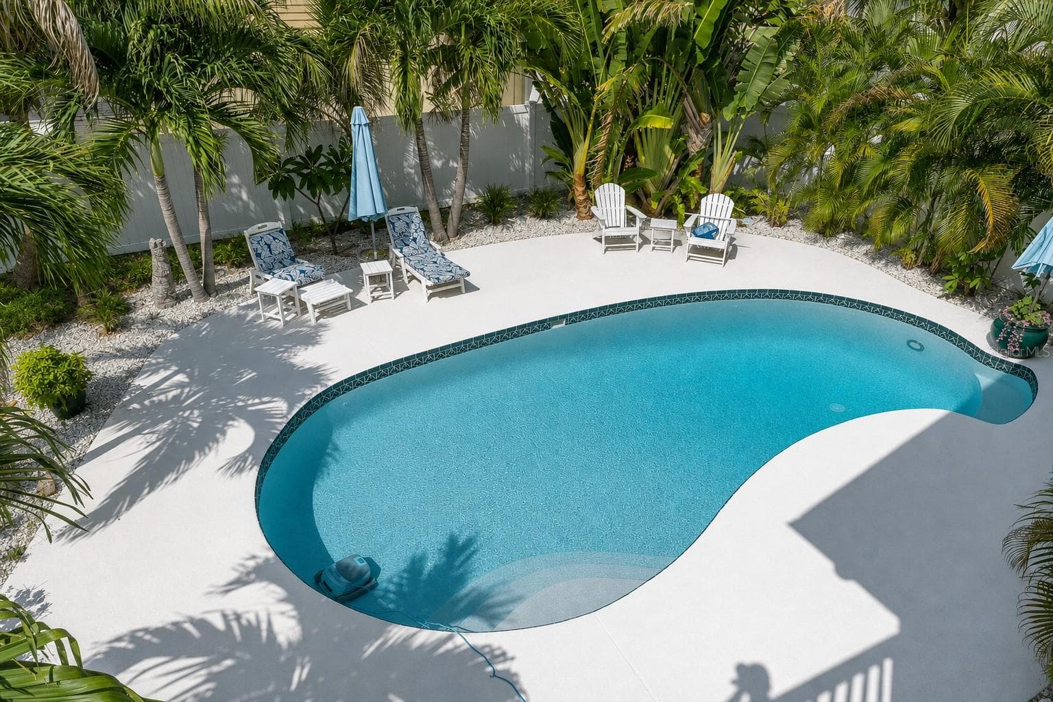 The inviting pool area features a spacious cool deck with plenty of room for lounge chairs, creating the perfect setting for relaxing & enjoying the Florida sunshine. - 6501 MOCKINGBIRD WAY S, GULFPORT