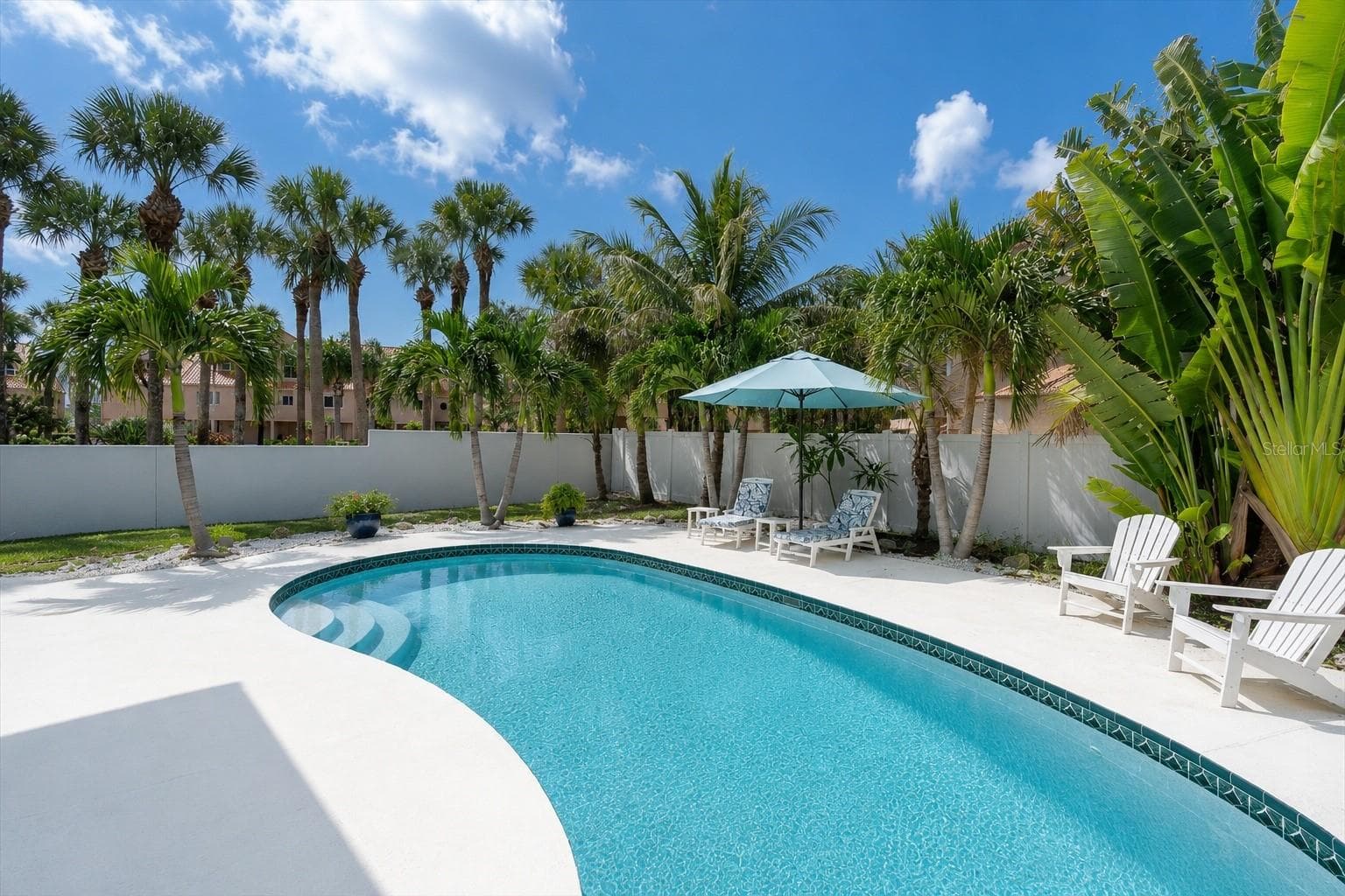 Surrounded by lush tropical landscaping, the pool area creates a private, resort like setting; your own peaceful Florida retreat right at home. - 6501 MOCKINGBIRD WAY S, GULFPORT