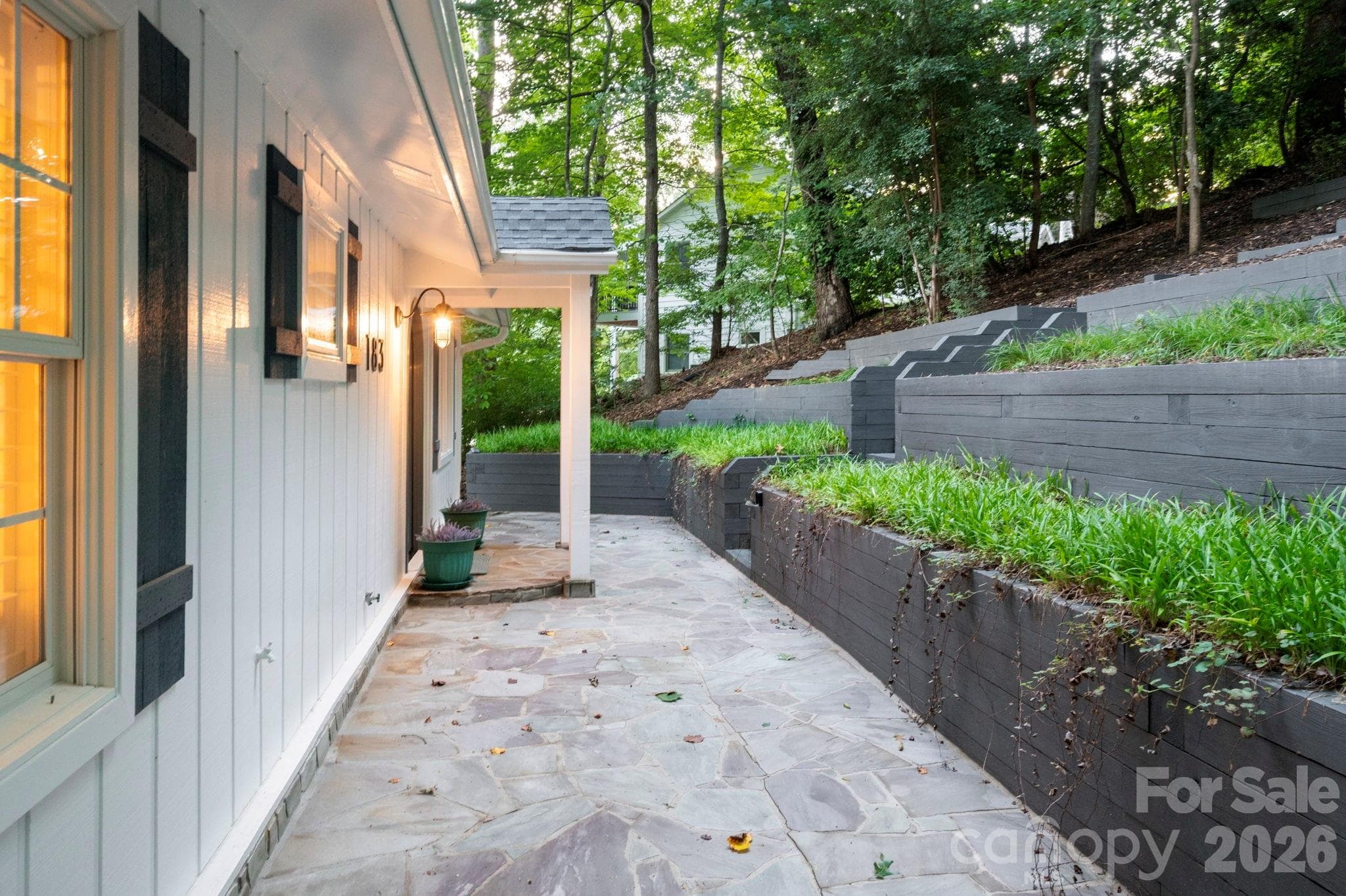Front stone patio and charming arched entry. - 183 Blarney Road, Lake Lure