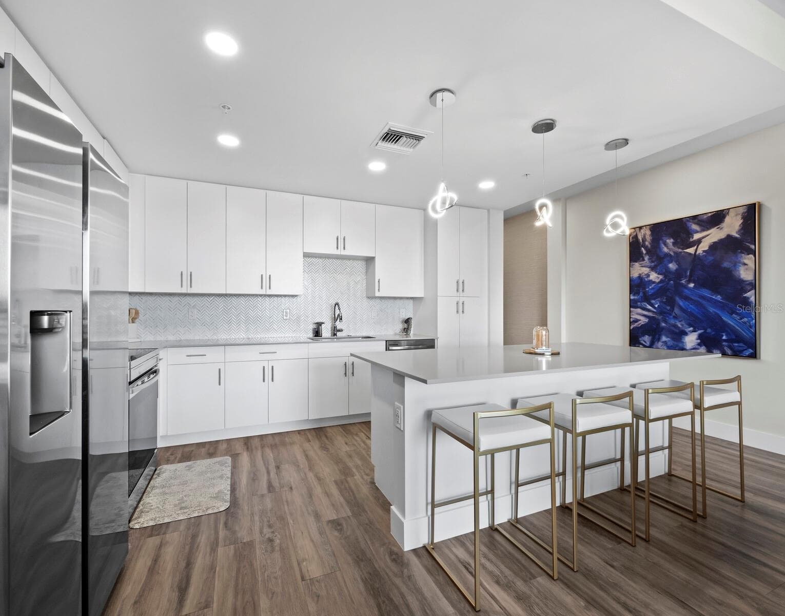 Luxury vinyl flooring & exquisite tile backsplash. Upgraded light fixtures over roomy breakfast bar - 1709 N TAMIAMI TRL #418, SARASOTA