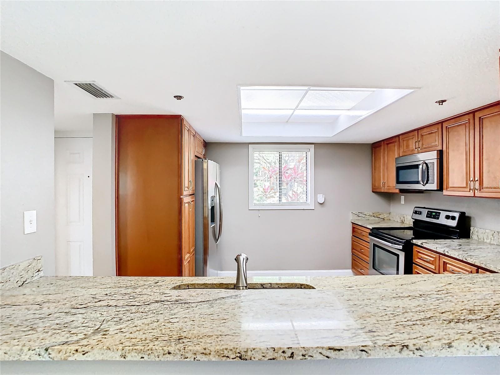 Sink has view of the dining area and outside - 976 E MICHIGAN ST #A, ORLANDO