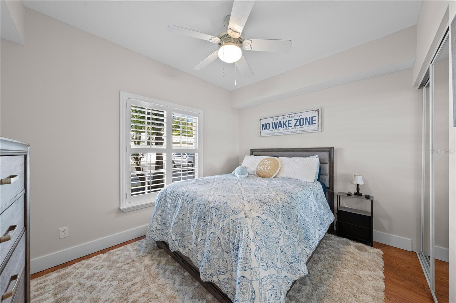 Bedroom 2 with beautiful plantation shutters and freshly painted with upgraded baseboards. - 13570 MYSTIC DR #102, SEBASTIAN