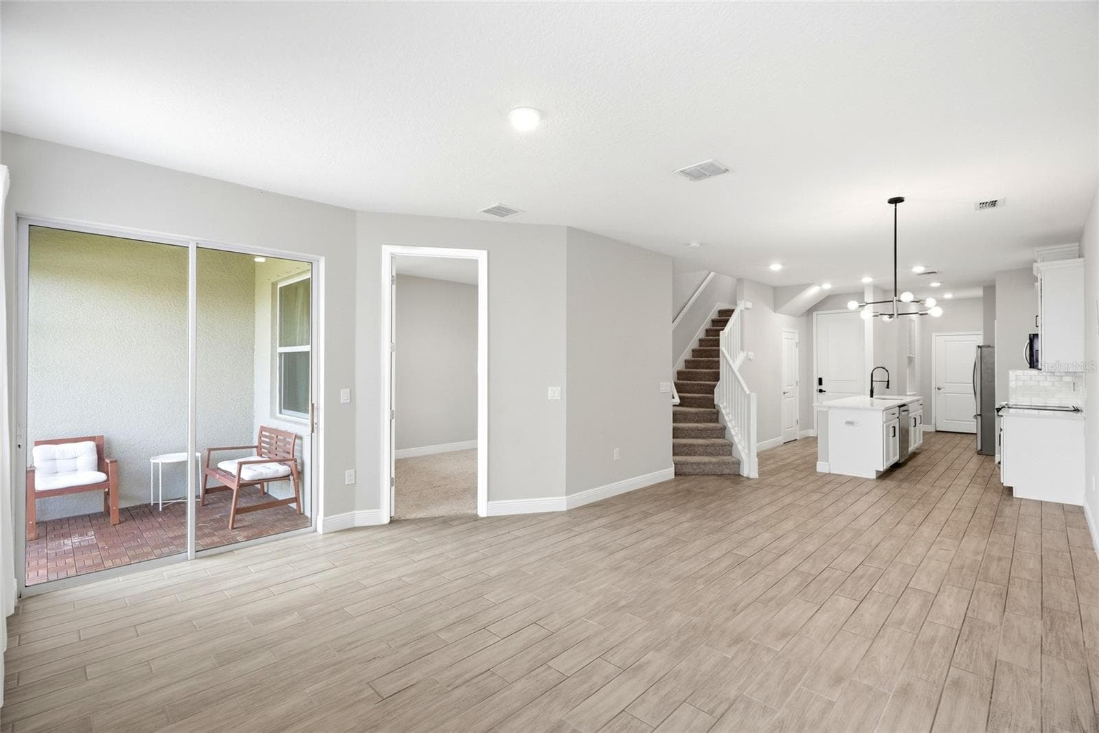 Living area access to the patio and primary bedroom on the main floor - 5282 NEIL DR, ST PETERSBURG