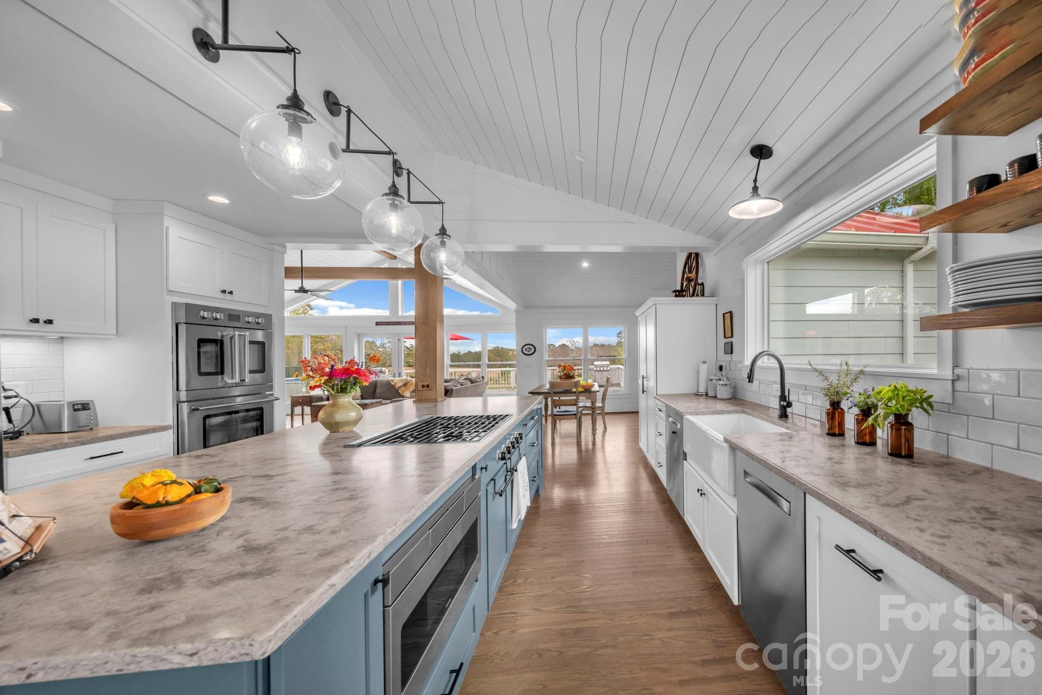 Honed quartz countertop, tile backsplash, farmhouse porcelain sink, & glass globe pendant light fixtures - 1260 Beaver Island Trail Road, Walnut Cove