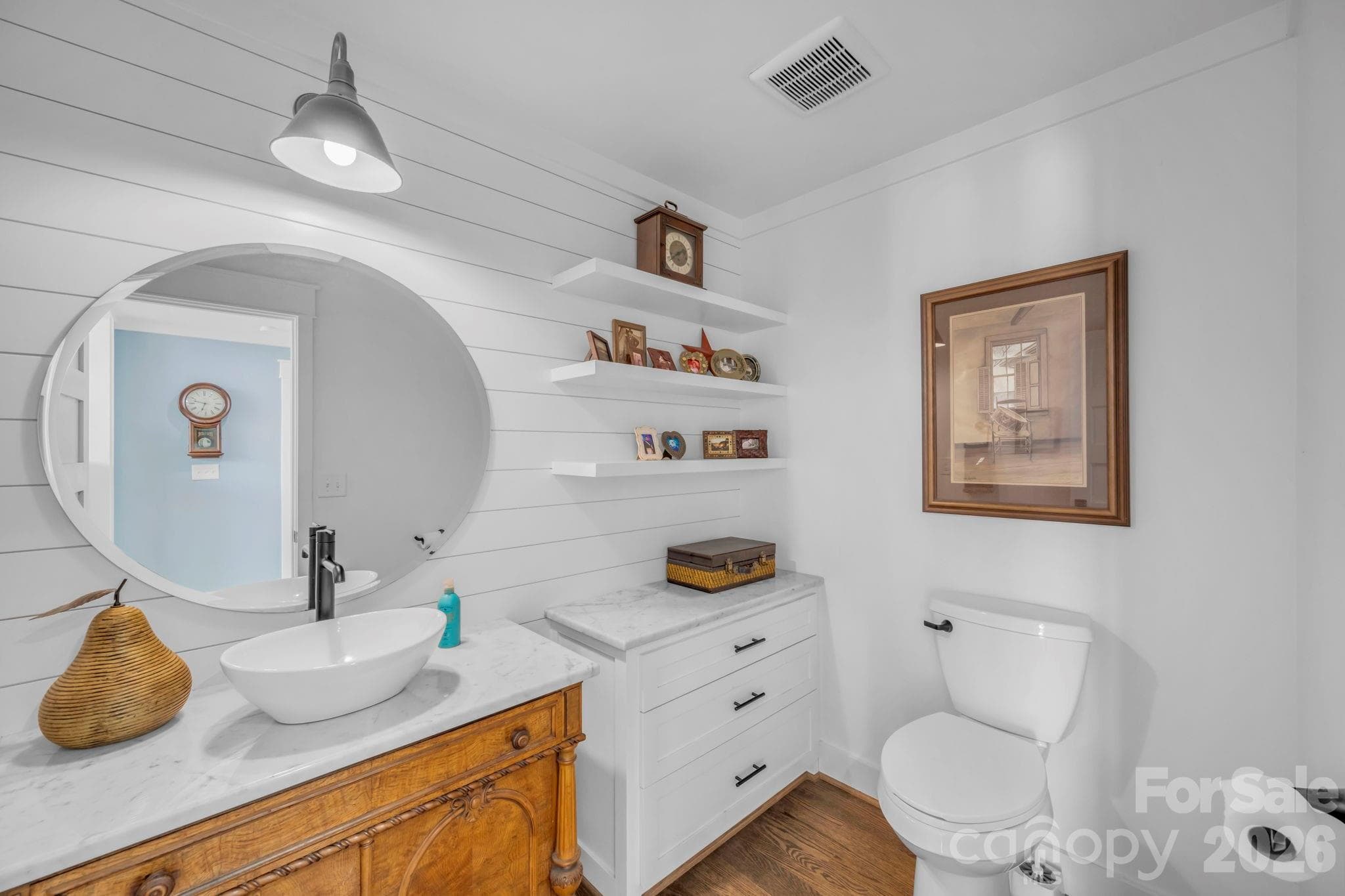 Main floor powder room w/ vessel sink and quartz countertop, 3 floating decorative shelves, and built in storage cabinet w/ quartz countertop - 1260 Beaver Island Trail Road, Walnut Cove