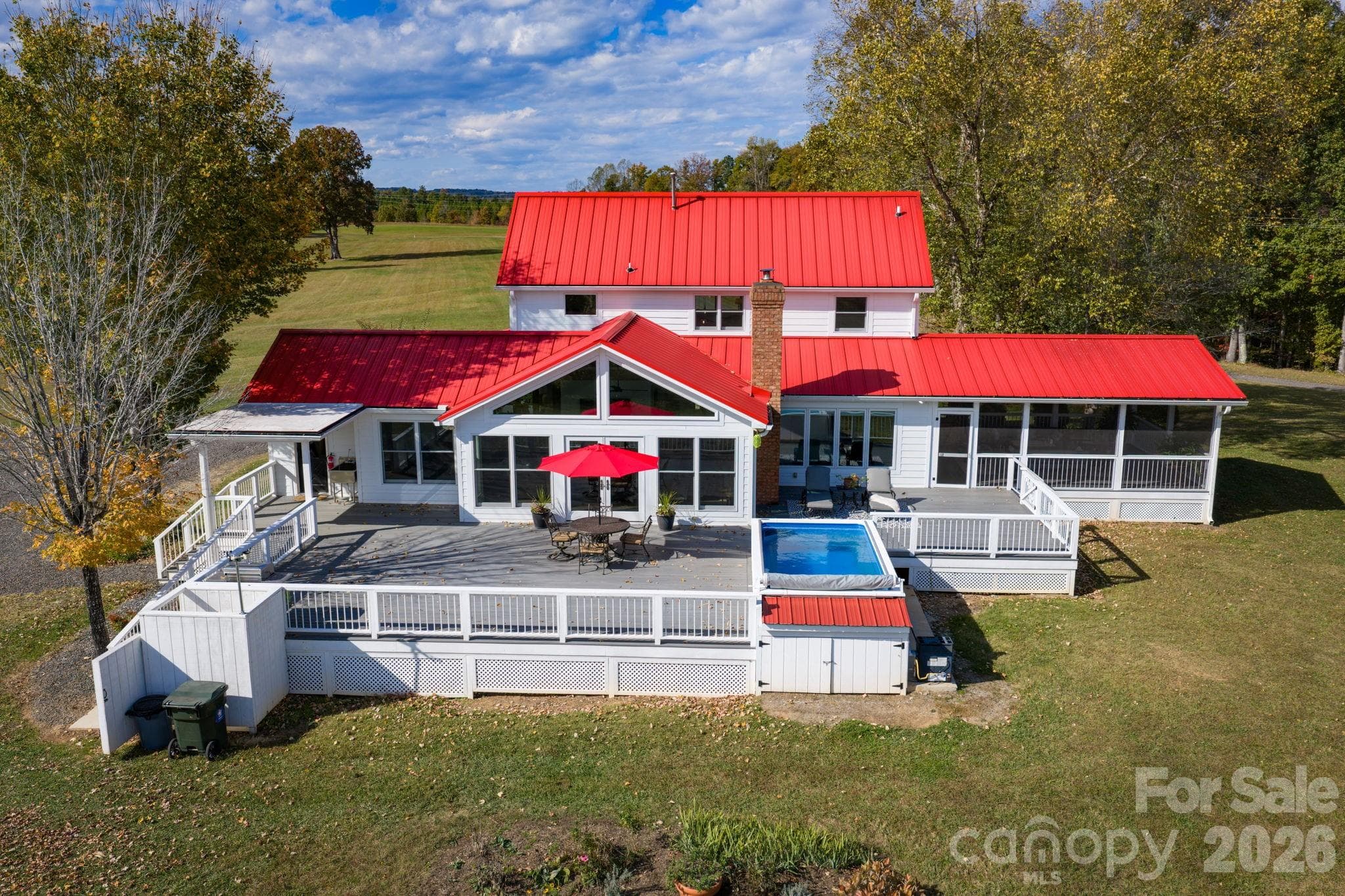 Large Trex style back deck, endless lap style pool (HydroDrive System), outdoor shower, direct access from the mudroom or great room, and views of rolling pasture and ponds - 1260 Beaver Island Trail Road, Walnut Cove