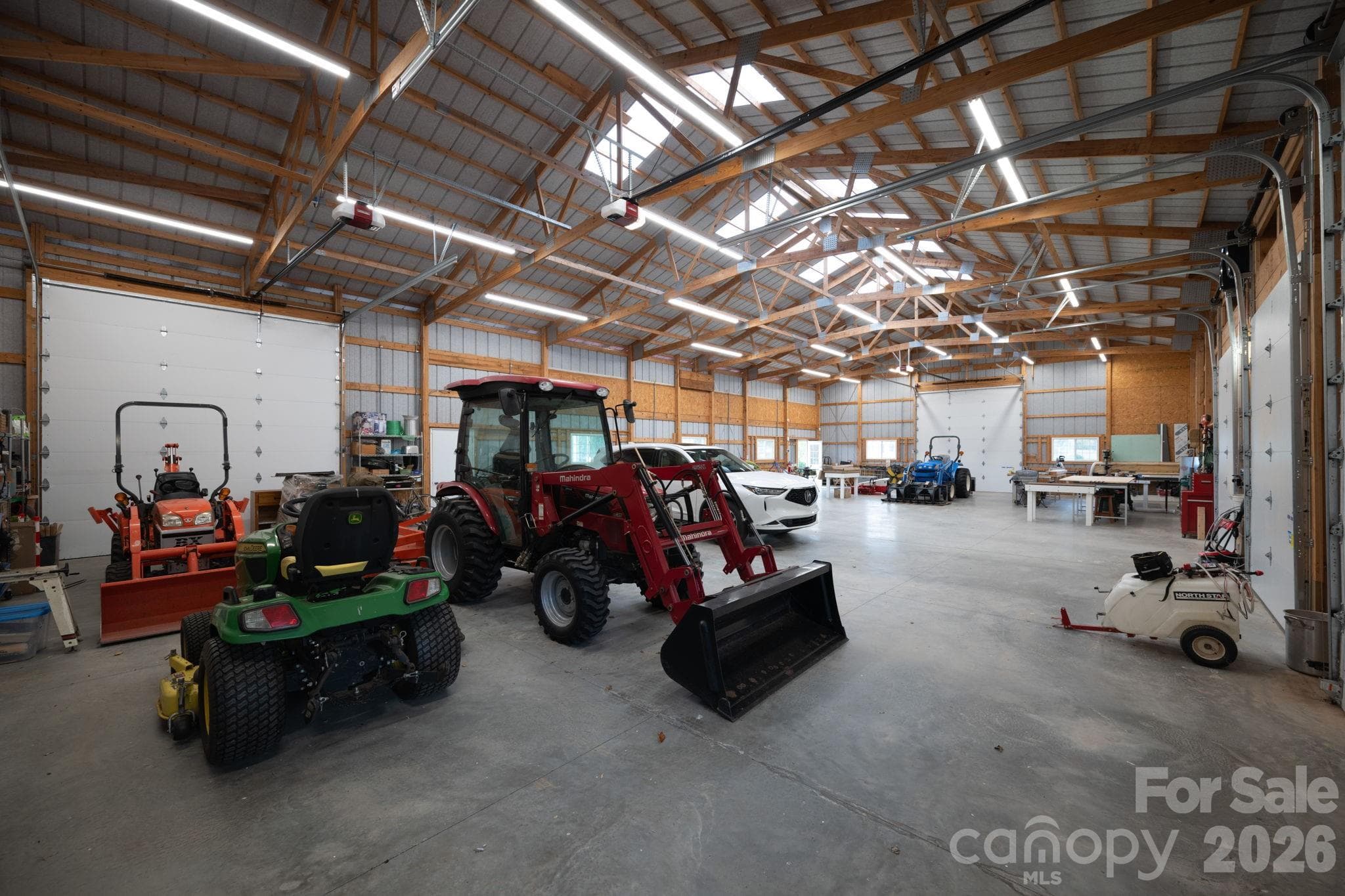 Interior of equipment building, 2 door entrances, and 4 motorized garage doors - 1260 Beaver Island Trail Road, Walnut Cove