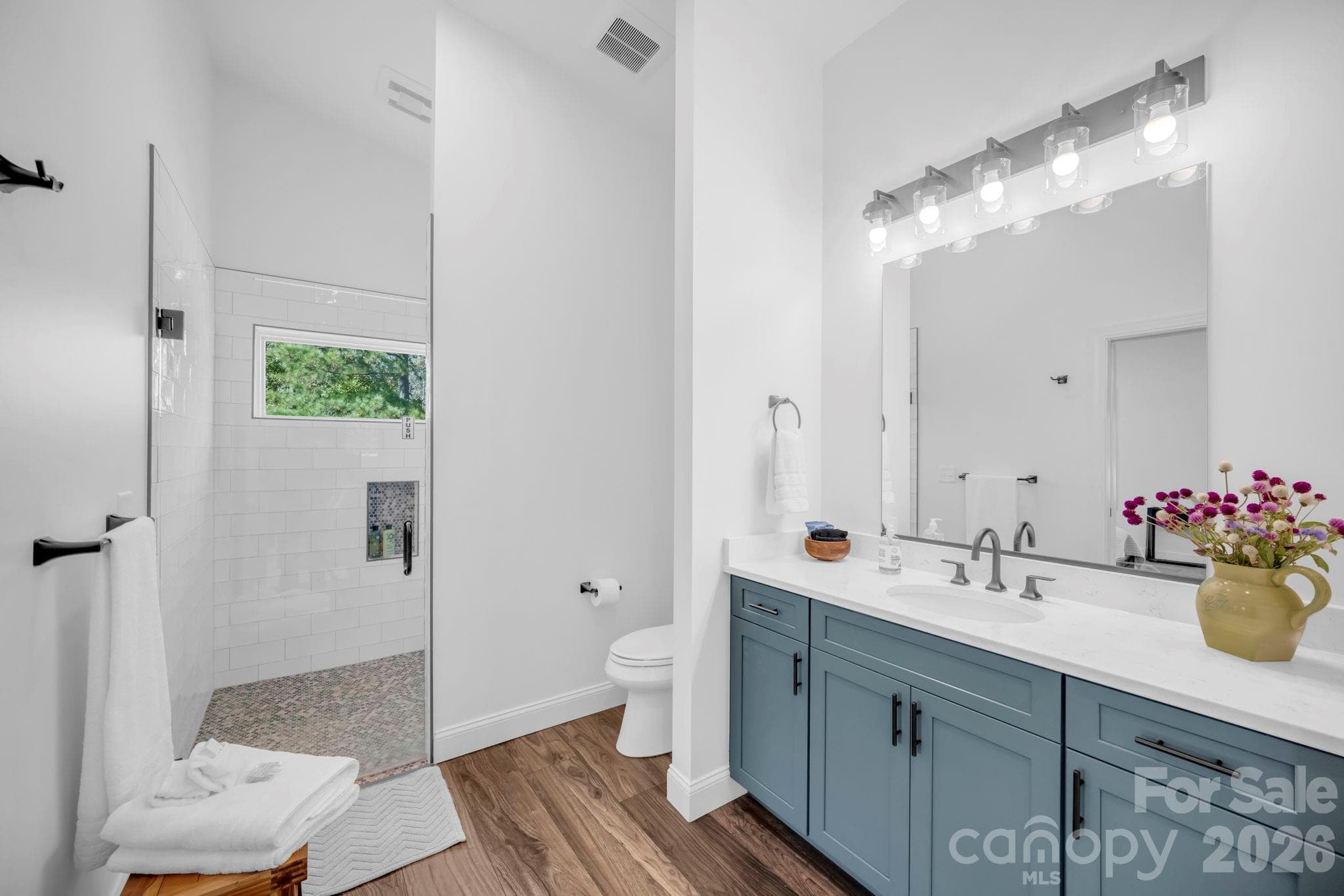 Full bathroom w/ frameless glass shower & tile surround, large vanity, and quartz countertop - 1260 Beaver Island Trail Road, Walnut Cove