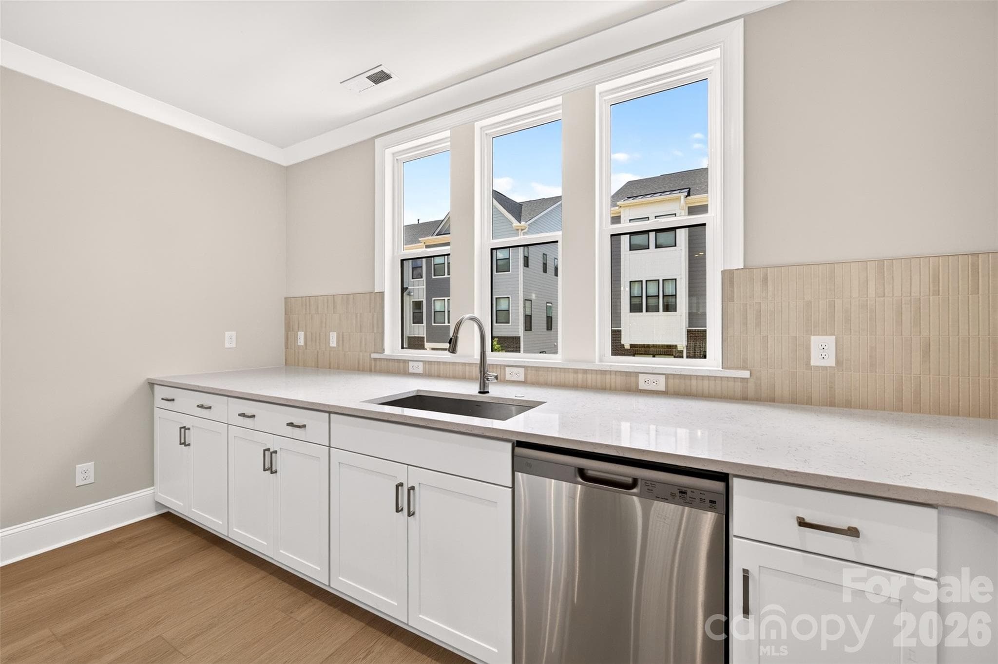 Large single bowl stainless steel sink facing large kitchen windows - 6008 Yellow Buckeye Drive, Charlotte