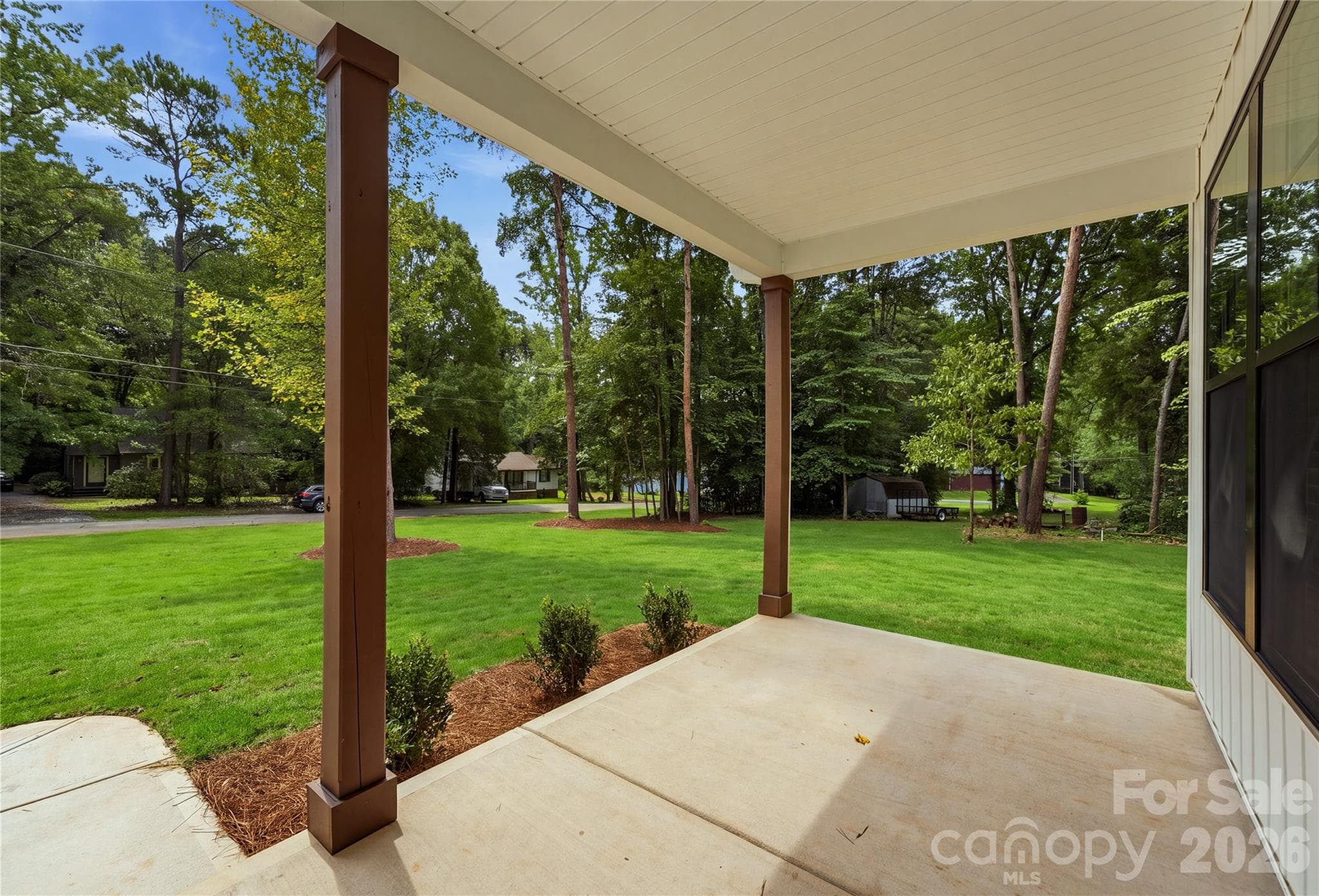 Inviting covered front porch. *grass digitally enhanced - 14133 Woodhurst Lane, Mint Hill