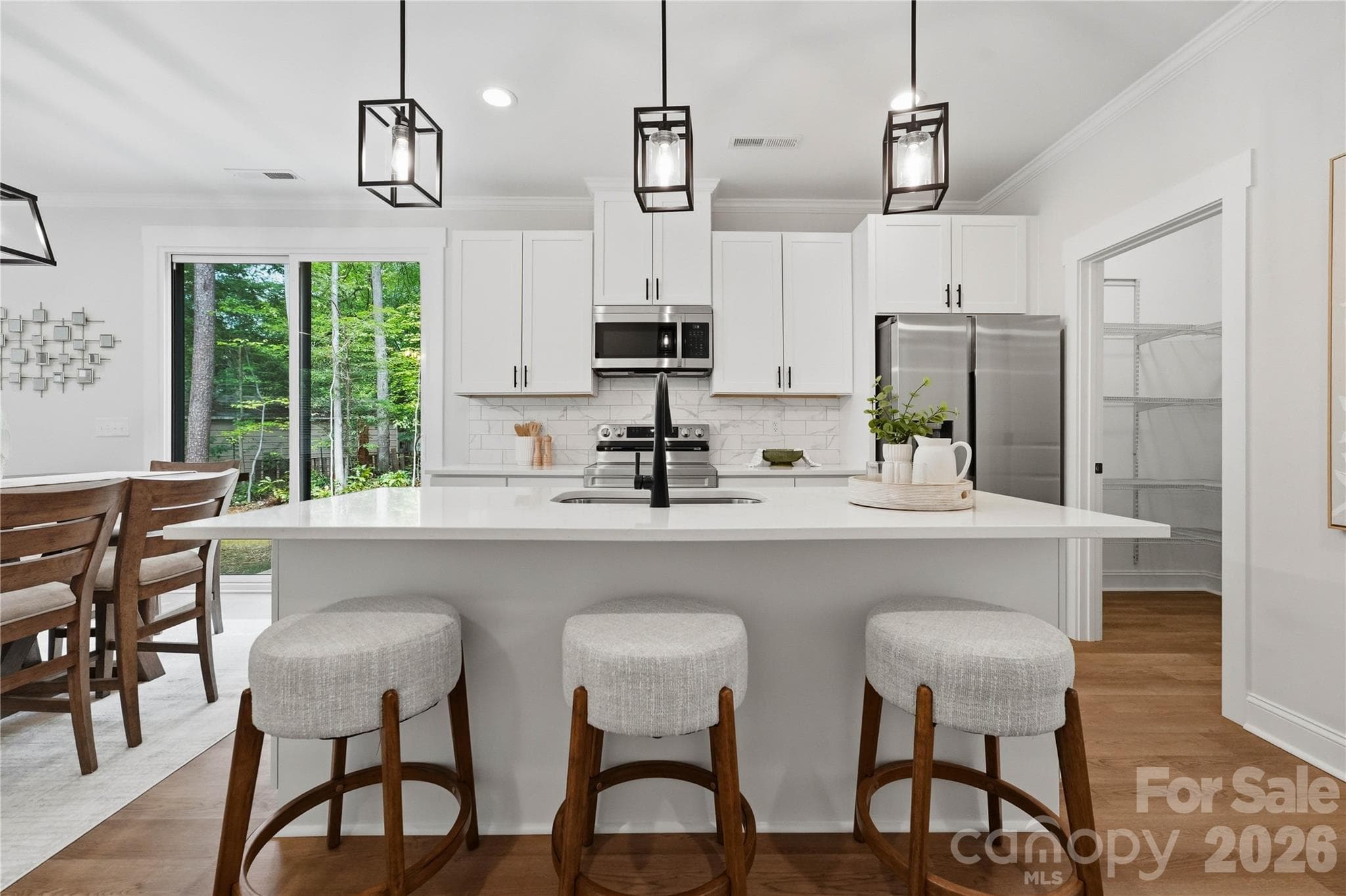Large kitchen island, quartz counters, 42" cabinets, tiled back splash and all stainless appliances. - 14133 Woodhurst Lane, Mint Hill