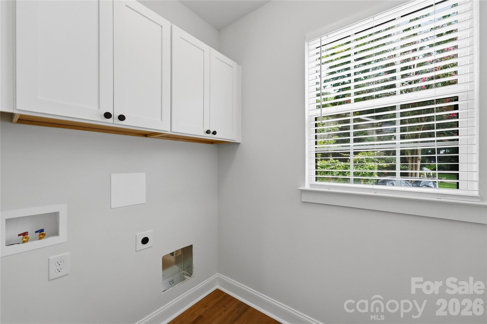 Laundry room with storage cabinets off kitchen - 14133 Woodhurst Lane, Mint Hill