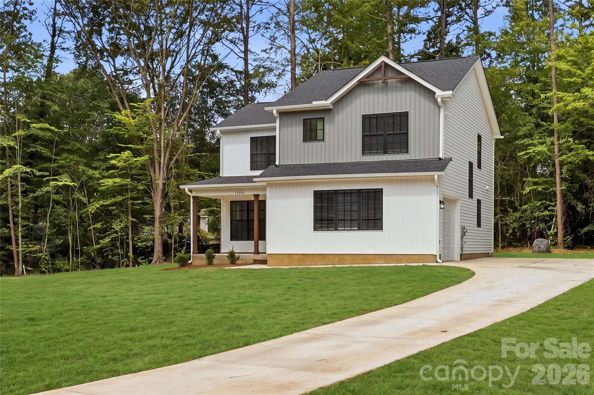 Large corner lot with oversized driveway and additional parking pad at top. *grass has been digitally enhanced - 14133 Woodhurst Lane, Mint Hill