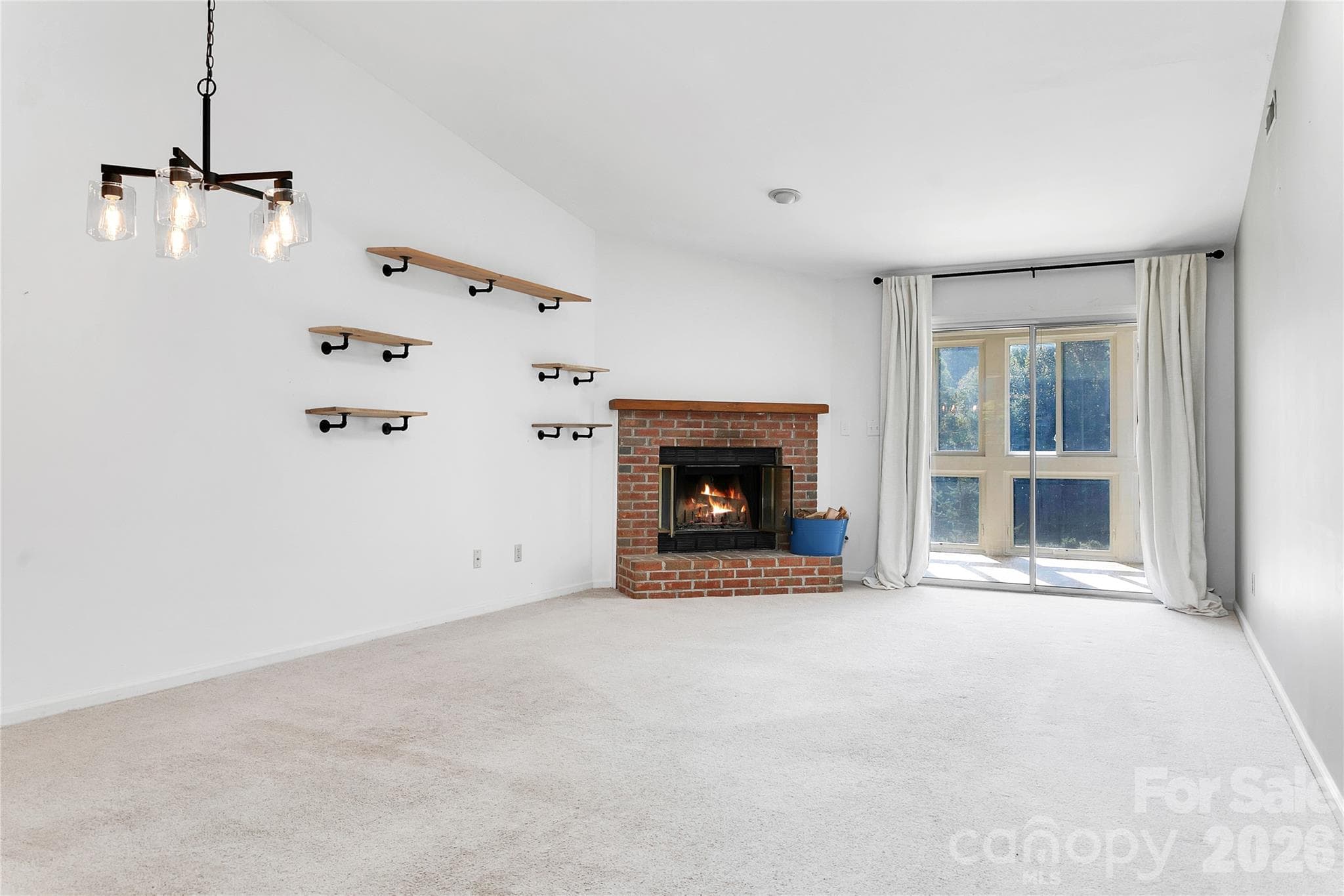 View of the Living Room Fireplace and decorative shelving. - 110 Lakeview Court, Brevard