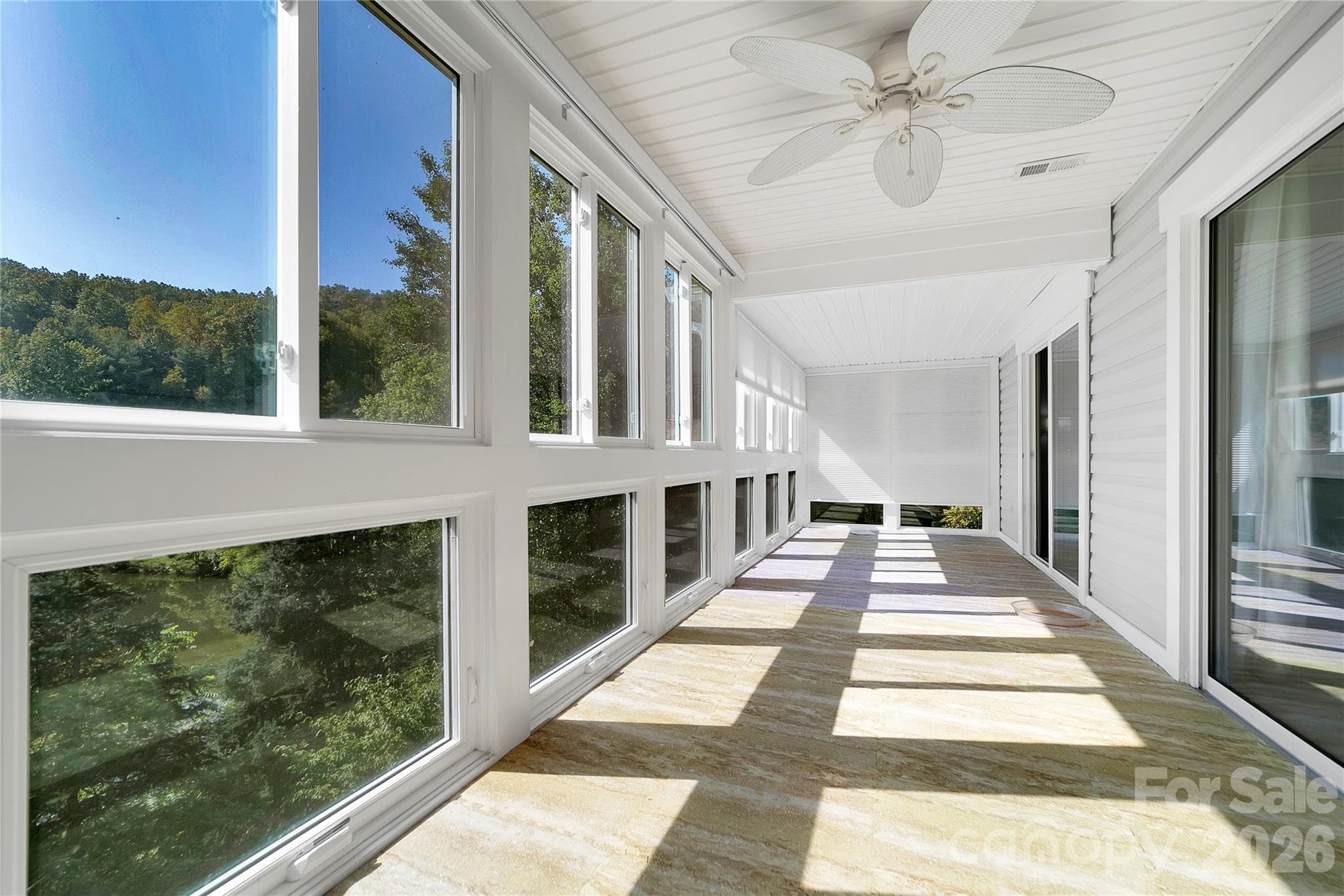 Enclosed sunroom with view of pond. - 110 Lakeview Court, Brevard