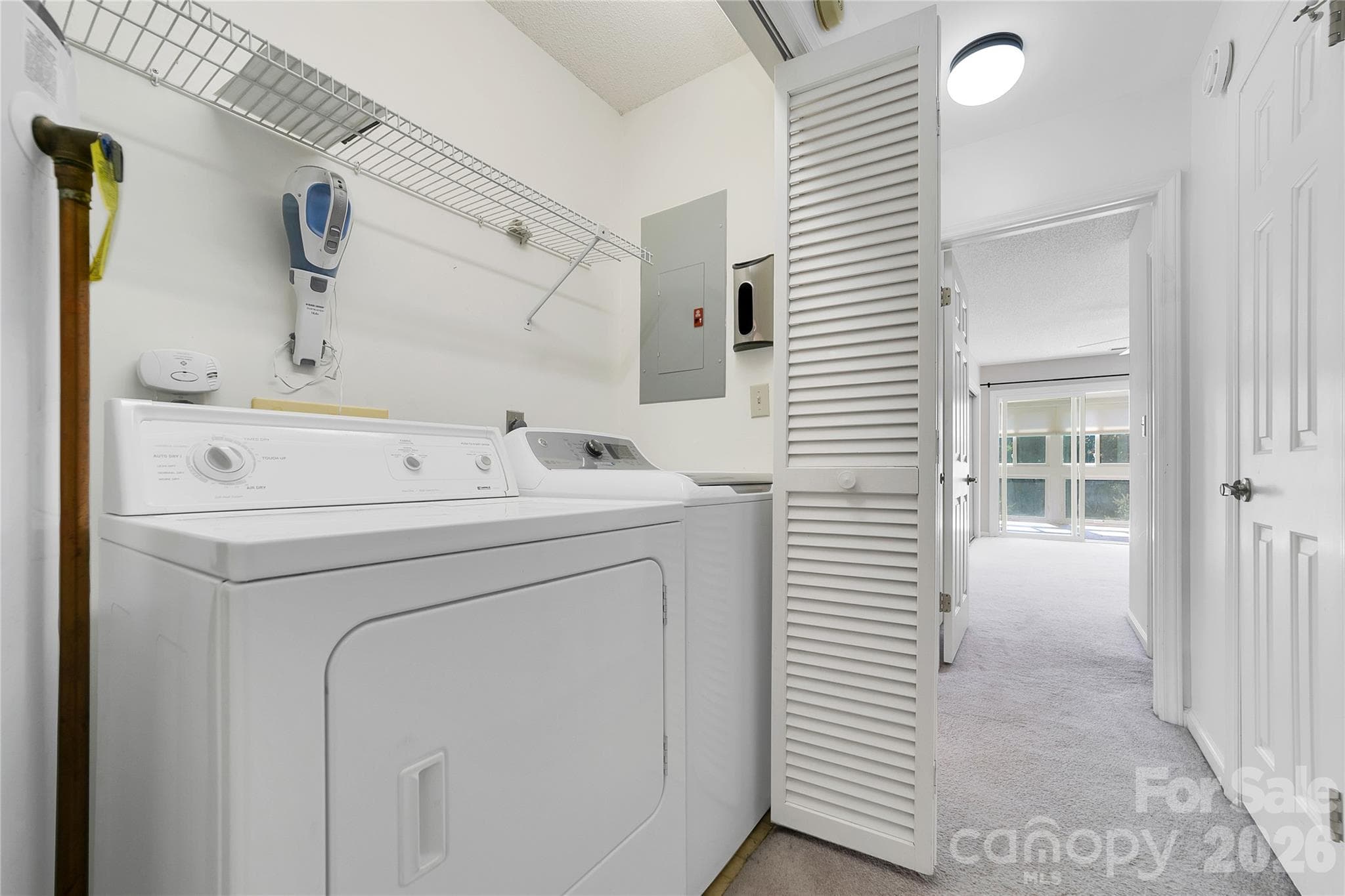 Laundry closet is in the hallway between bedrooms. - 110 Lakeview Court, Brevard