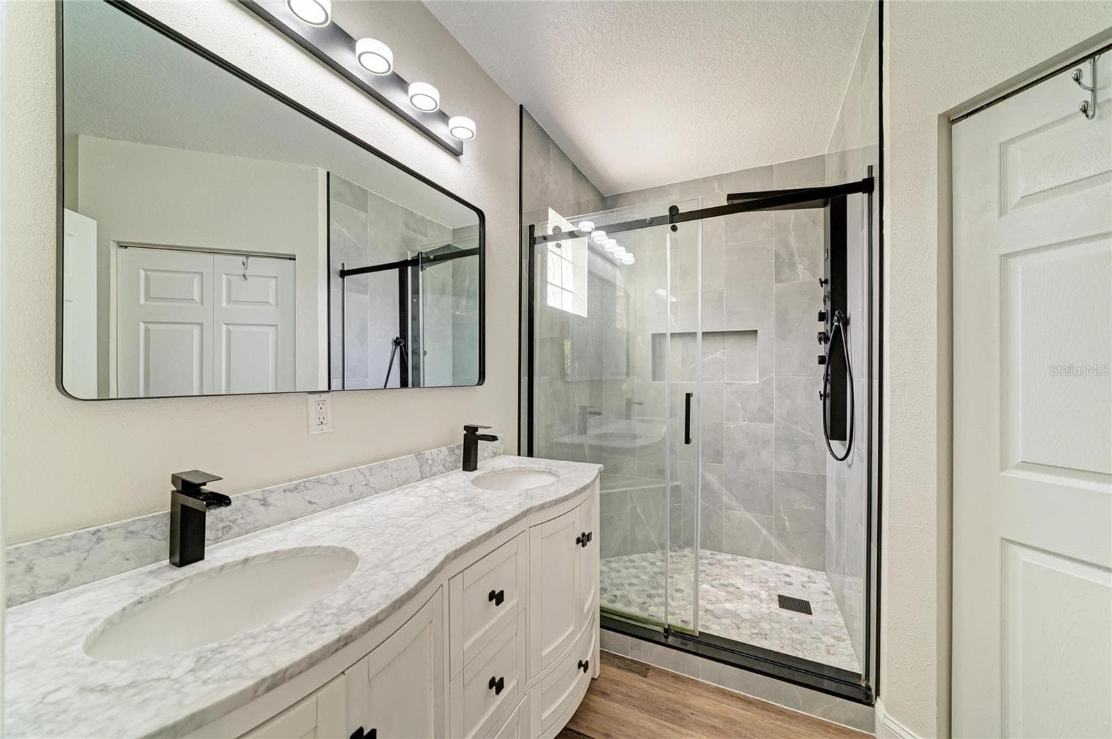 Primary ensuite bathroom has been newly remodeled with double sink vanity and new shower. - 3220 37TH TER E, BRADENTON