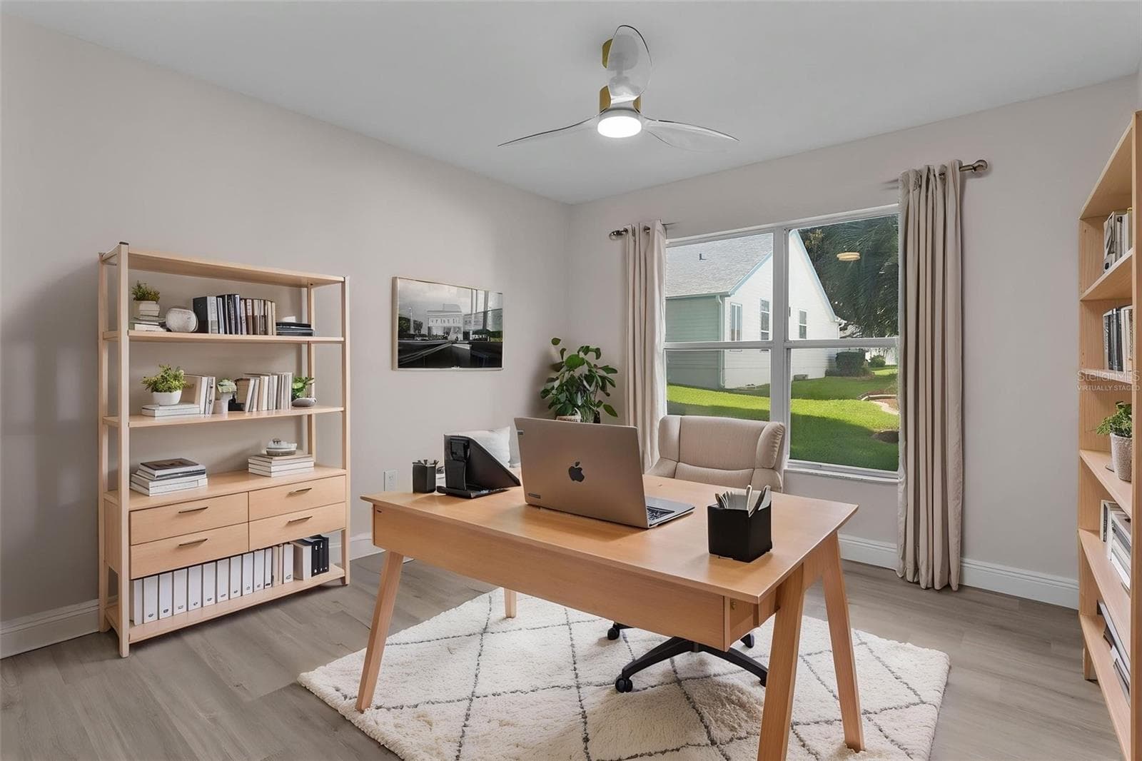 Guest bedroom one VIRTUALLY STAGED as an office. - 1012 DIEGO CT, LADY LAKE
