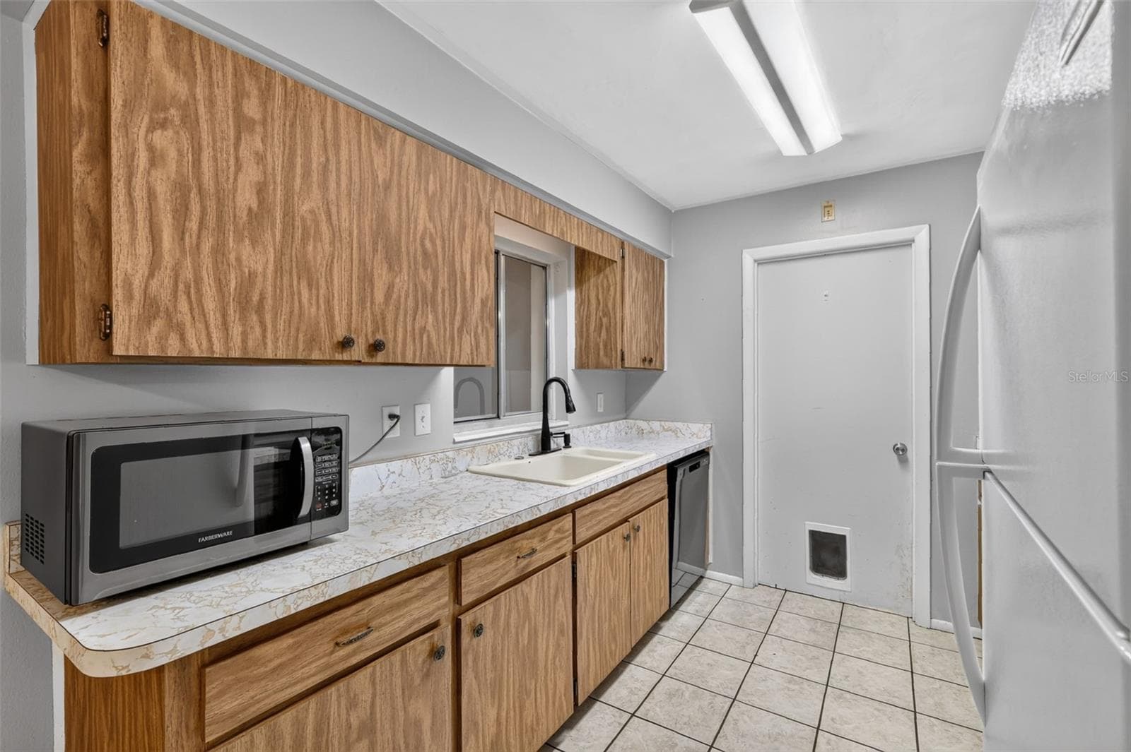 Easy Access To Laundry/Utility Room from Kitchen - 1305 ORANGE AVE, TAVARES